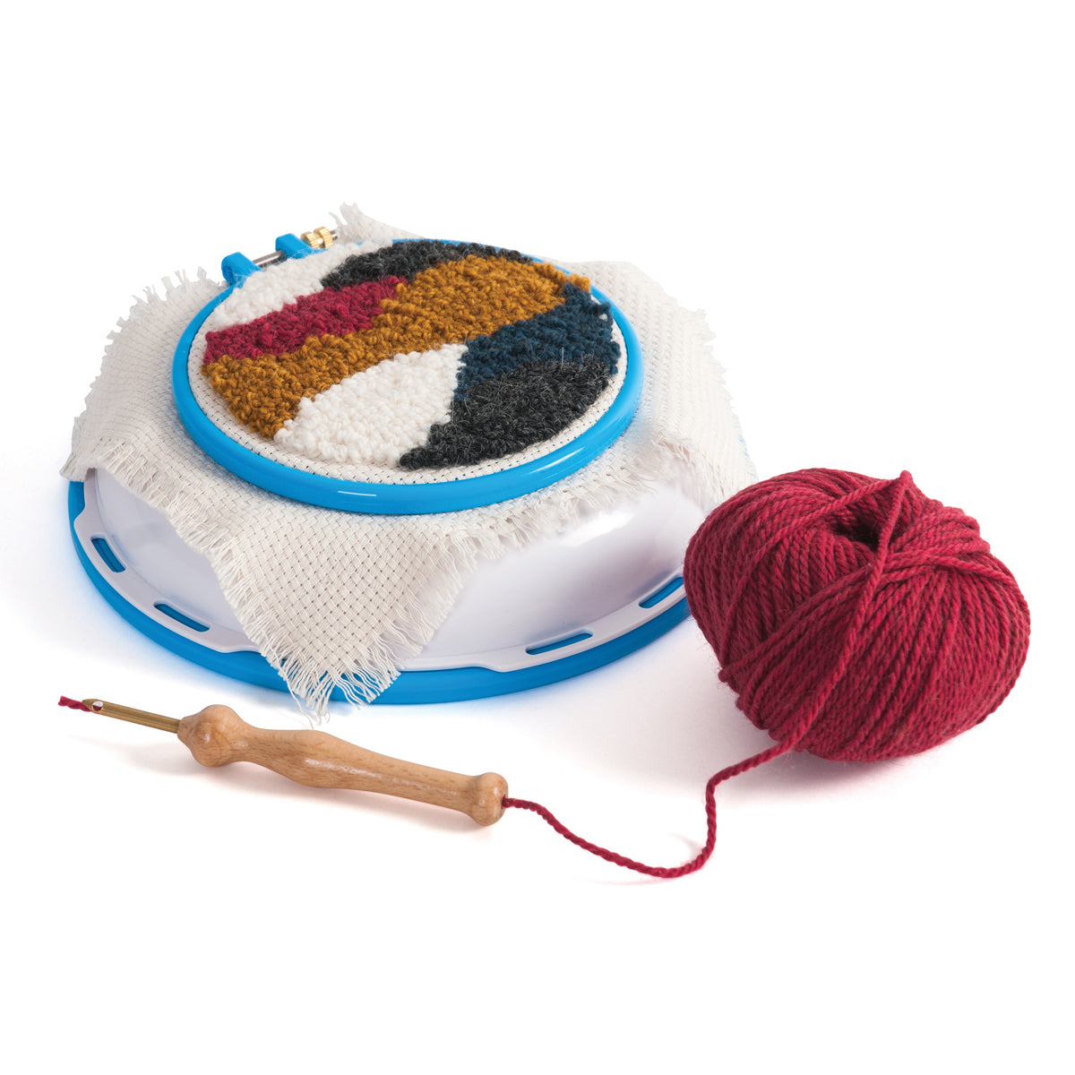 3-in-1 punch needle hoop stand with red yarn, wooden punch needle tool, and colorful fabric art.