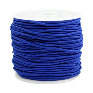A spool of royal blue elastic cord for jewelry making on a white plastic reel.