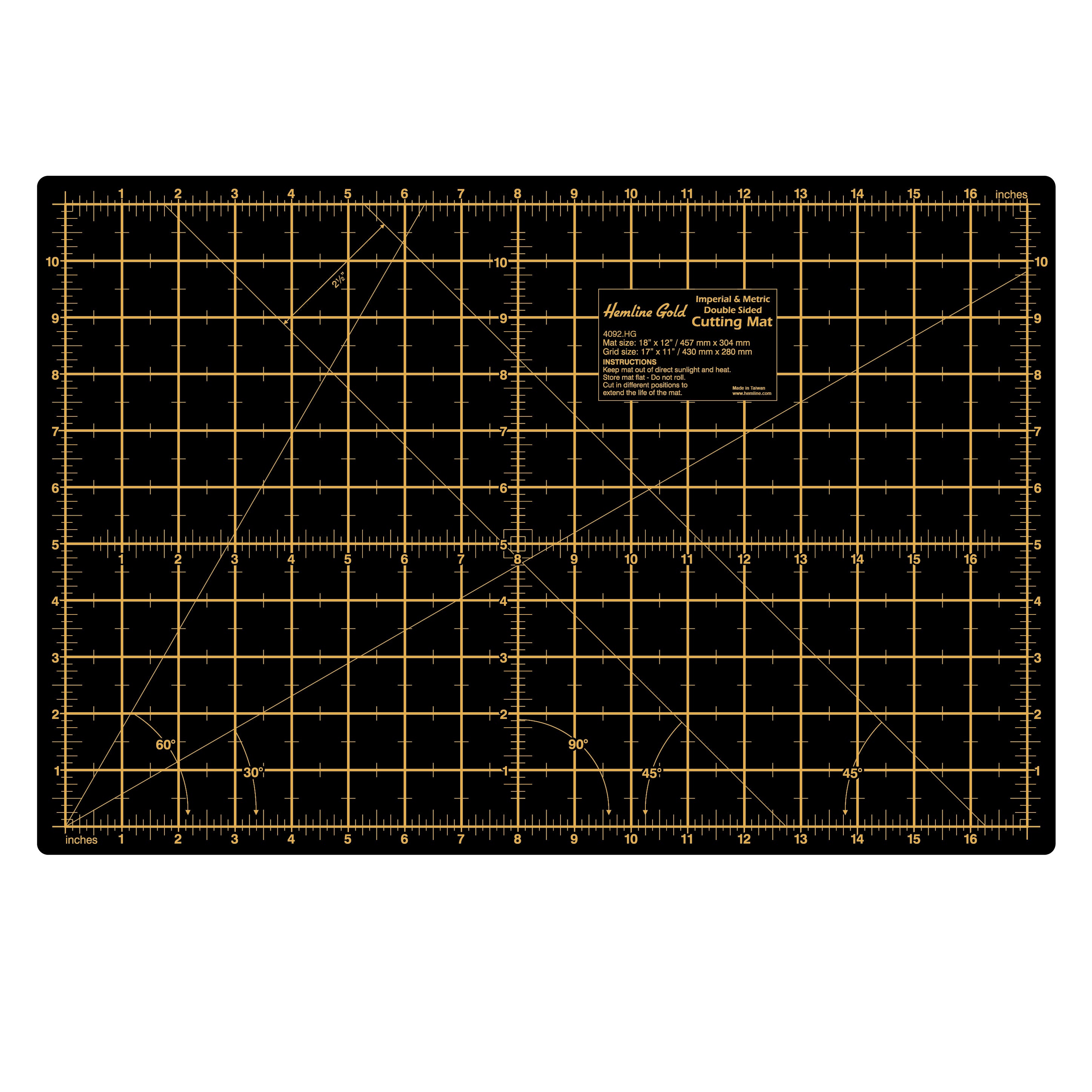 A black self-healing cutting mat with gold imperial and metric grid lines and angle markings.