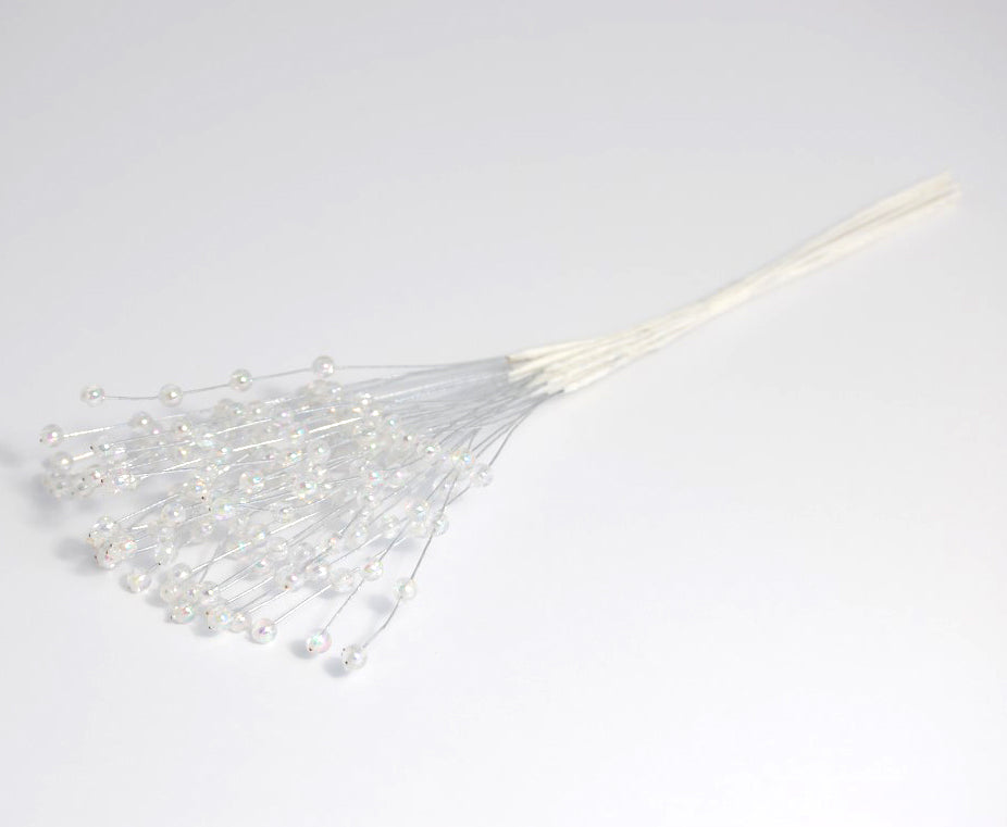 Pack of 12 iridescent clear 6mm oval pearl picks on silver wire stems.