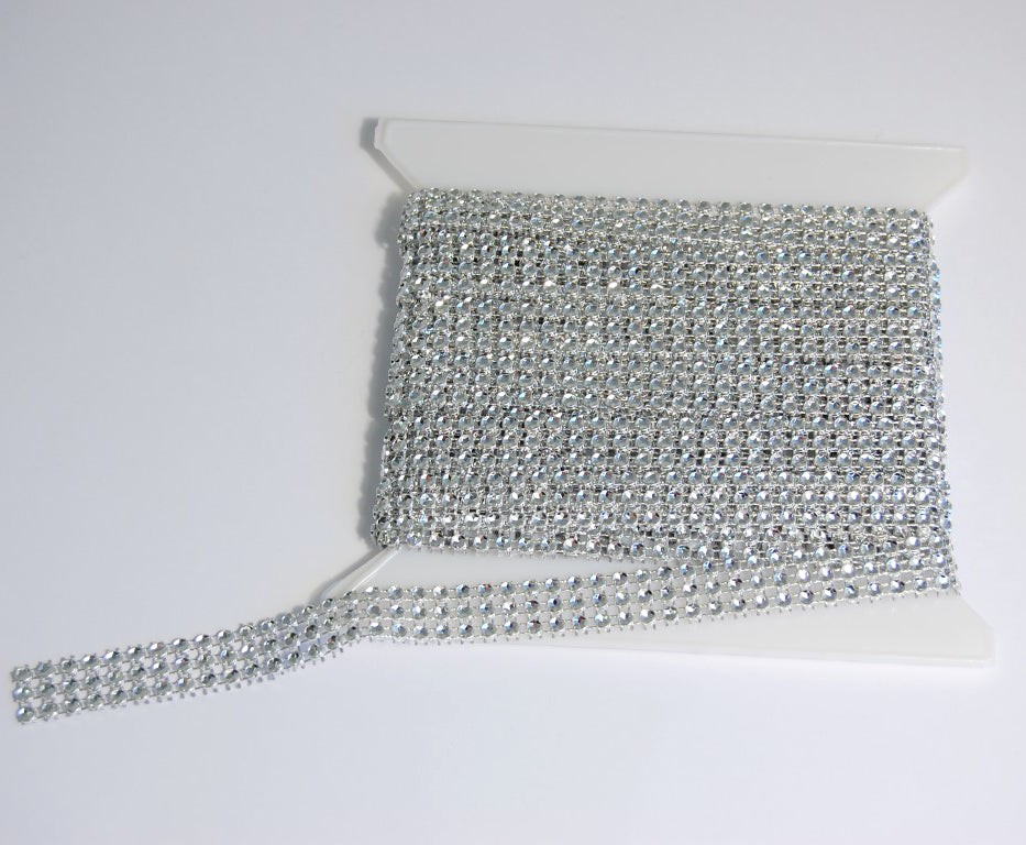 Groves three-line clear jewel gem trim on a white spool.