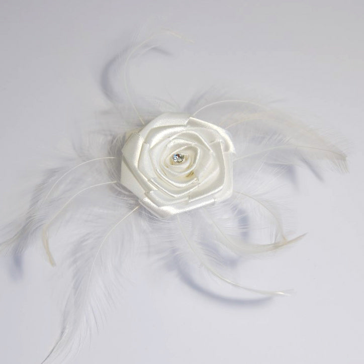 White ribbon rose with a diamante center and delicate feather accents on a pin clip.