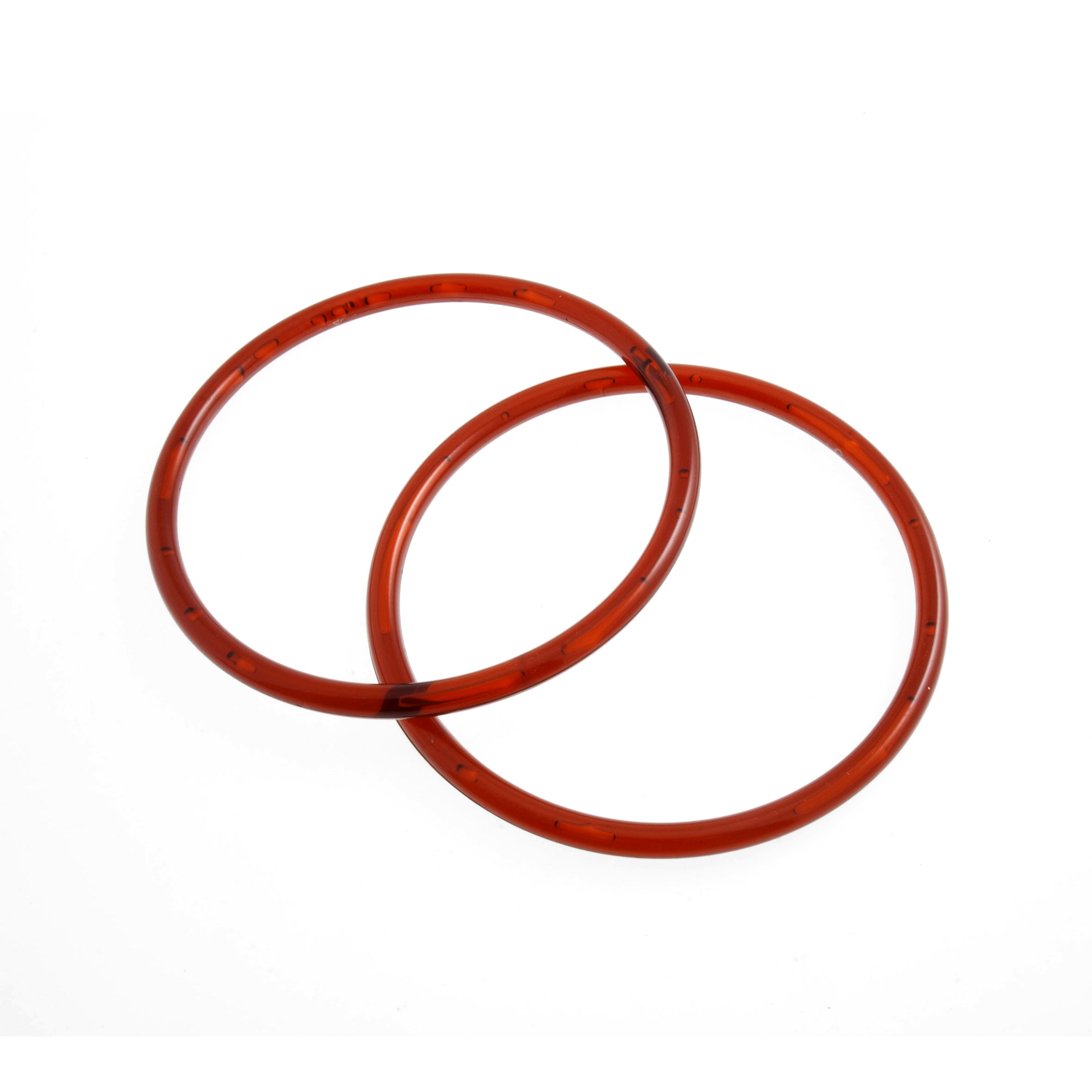 Two round, amber-colored plastic bag handles with a 13cm diameter shown on a white background.