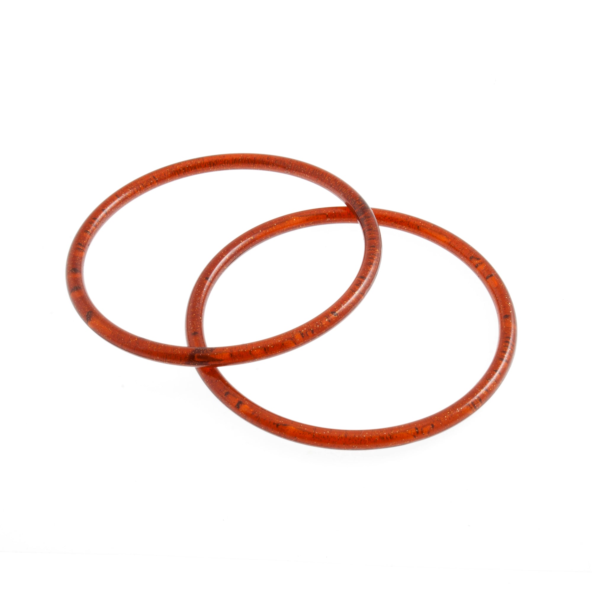 Two round, amber-colored plastic bag handles with a 13cm diameter on a white background.
