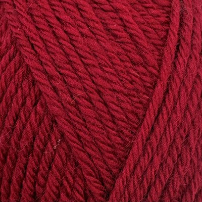 Close-up of Stylecraft Naturals Pure Wool DK yarn in a deep claret red color.