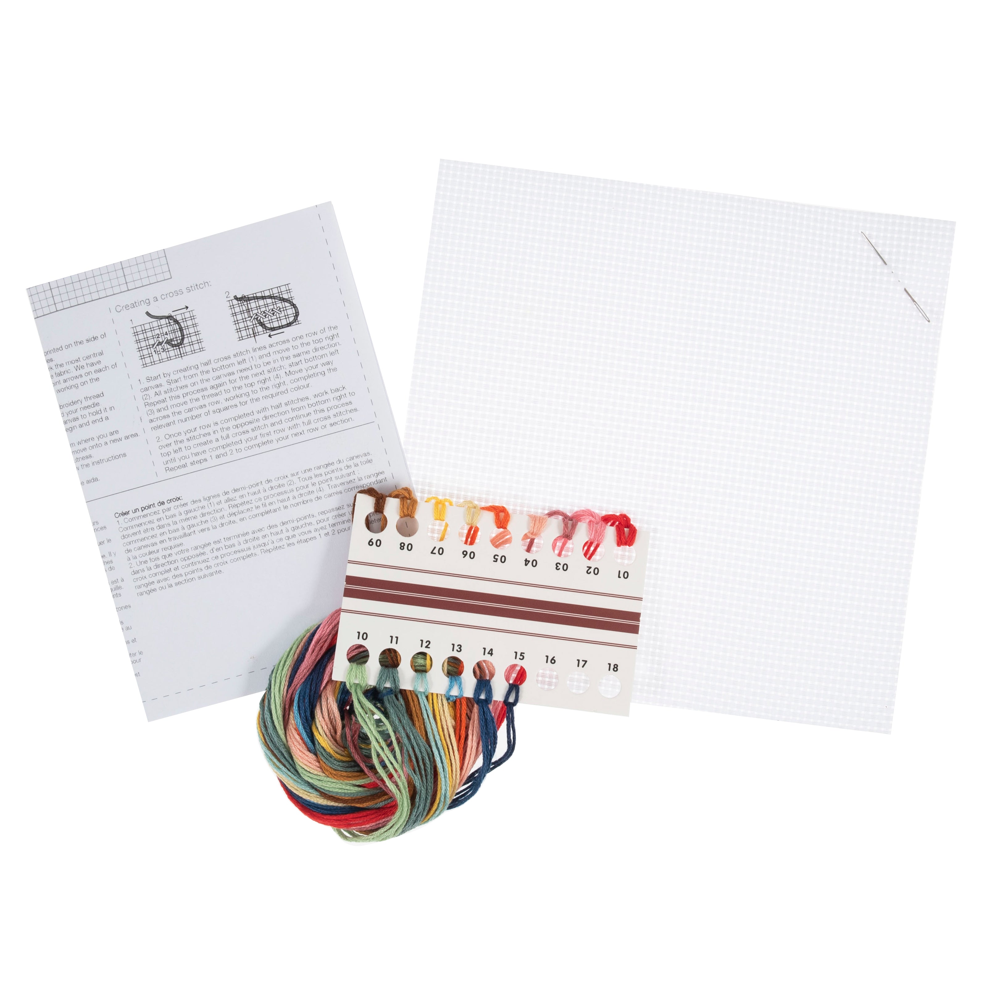 Counted cross stitch kit featuring aida fabric, needle, instructions, and colorful embroidery threads.