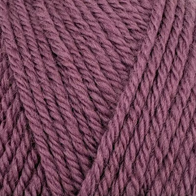 Close-up of Stylecraft Naturals Pure Wool DK yarn in a deep grape purple shade.