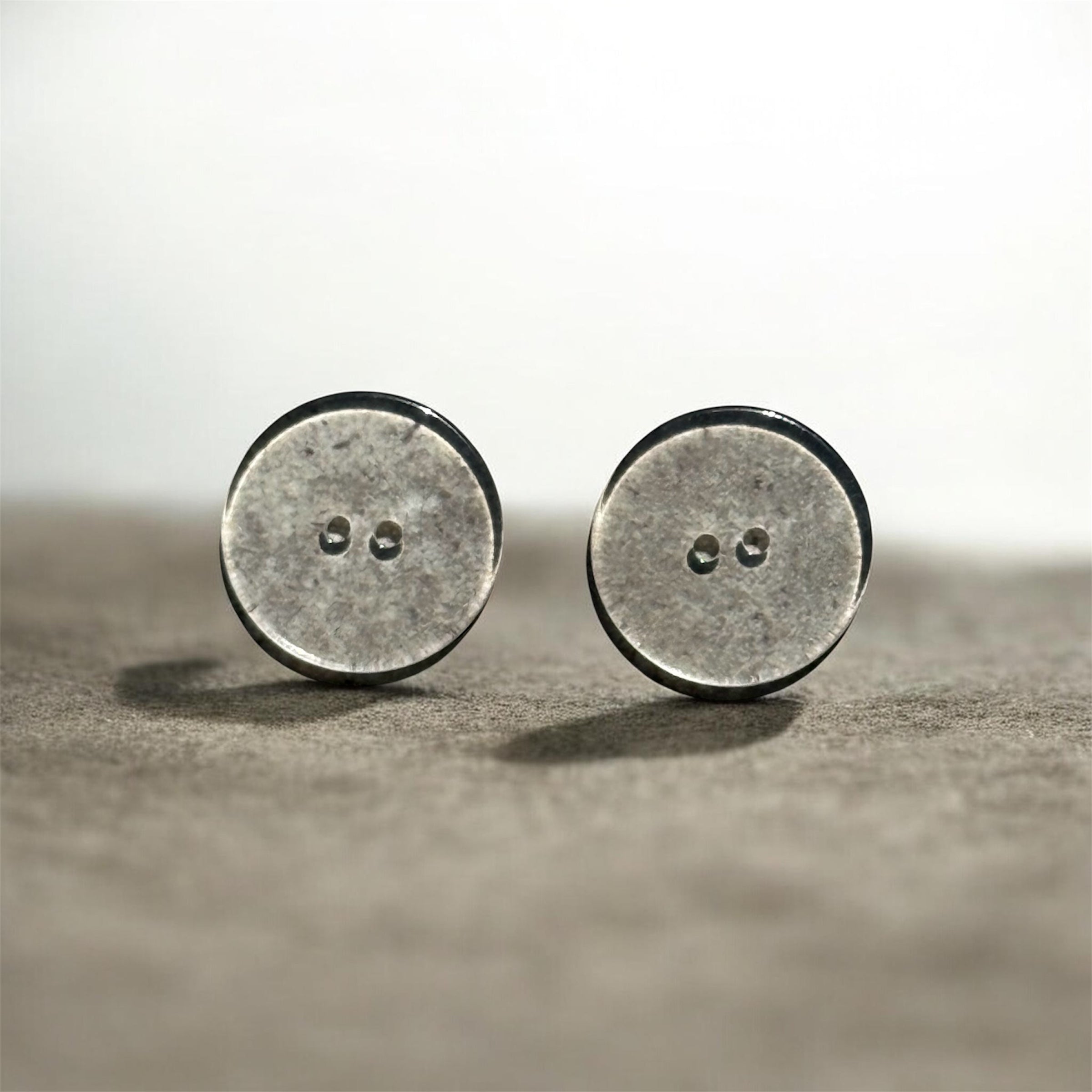 Two 15mm transparent resin buttons with a 2-hole design and smooth flatback construction.