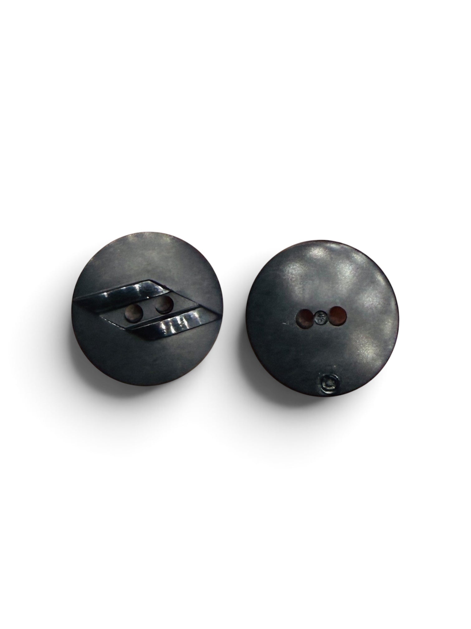 Two 20mm round black resin 2-hole designer sewing buttons with a subtle sheen on a white background.