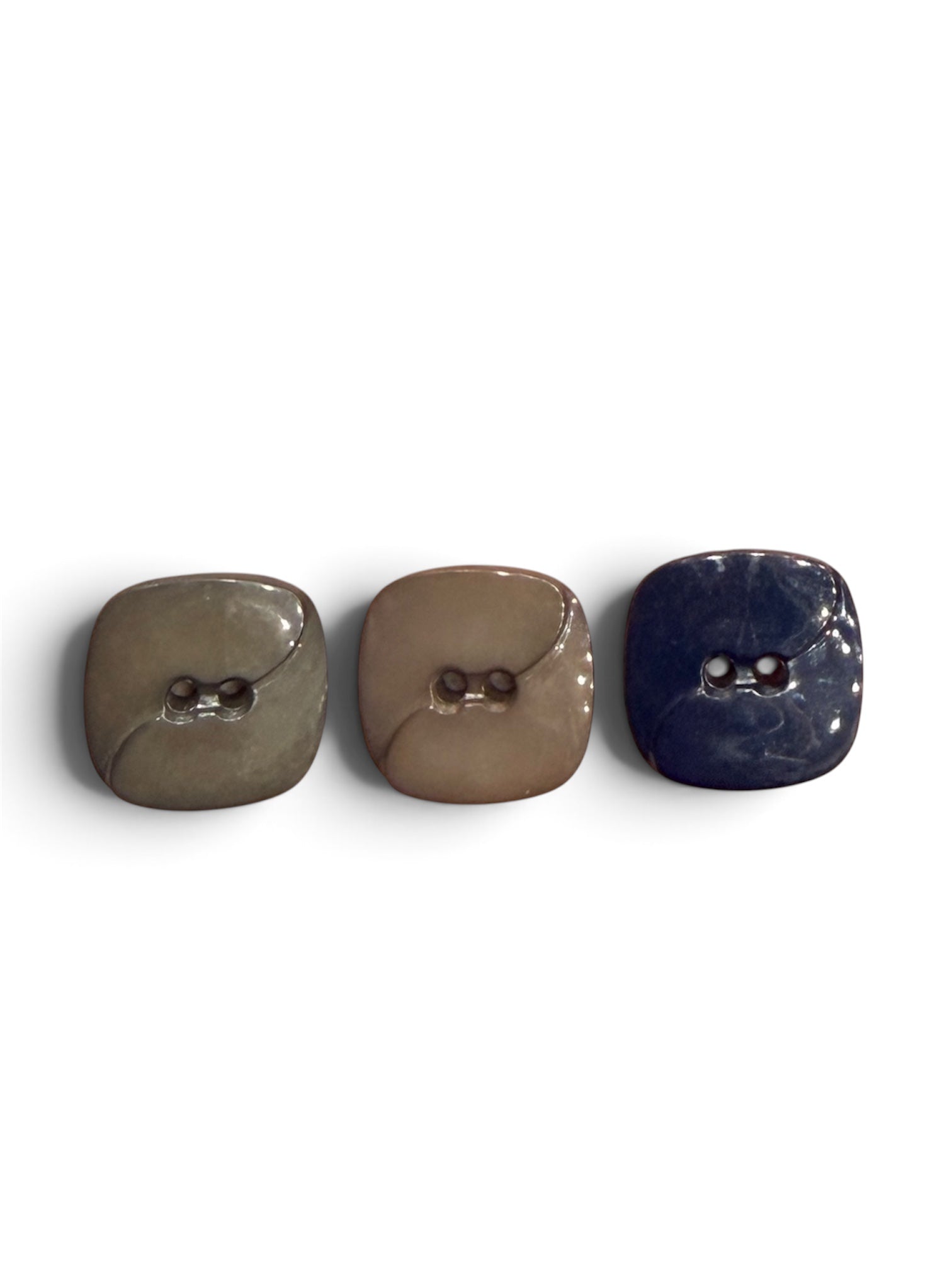 Three 16mm 2-hole resin sewing buttons in grey, brown, and navy blue with a matte finish.