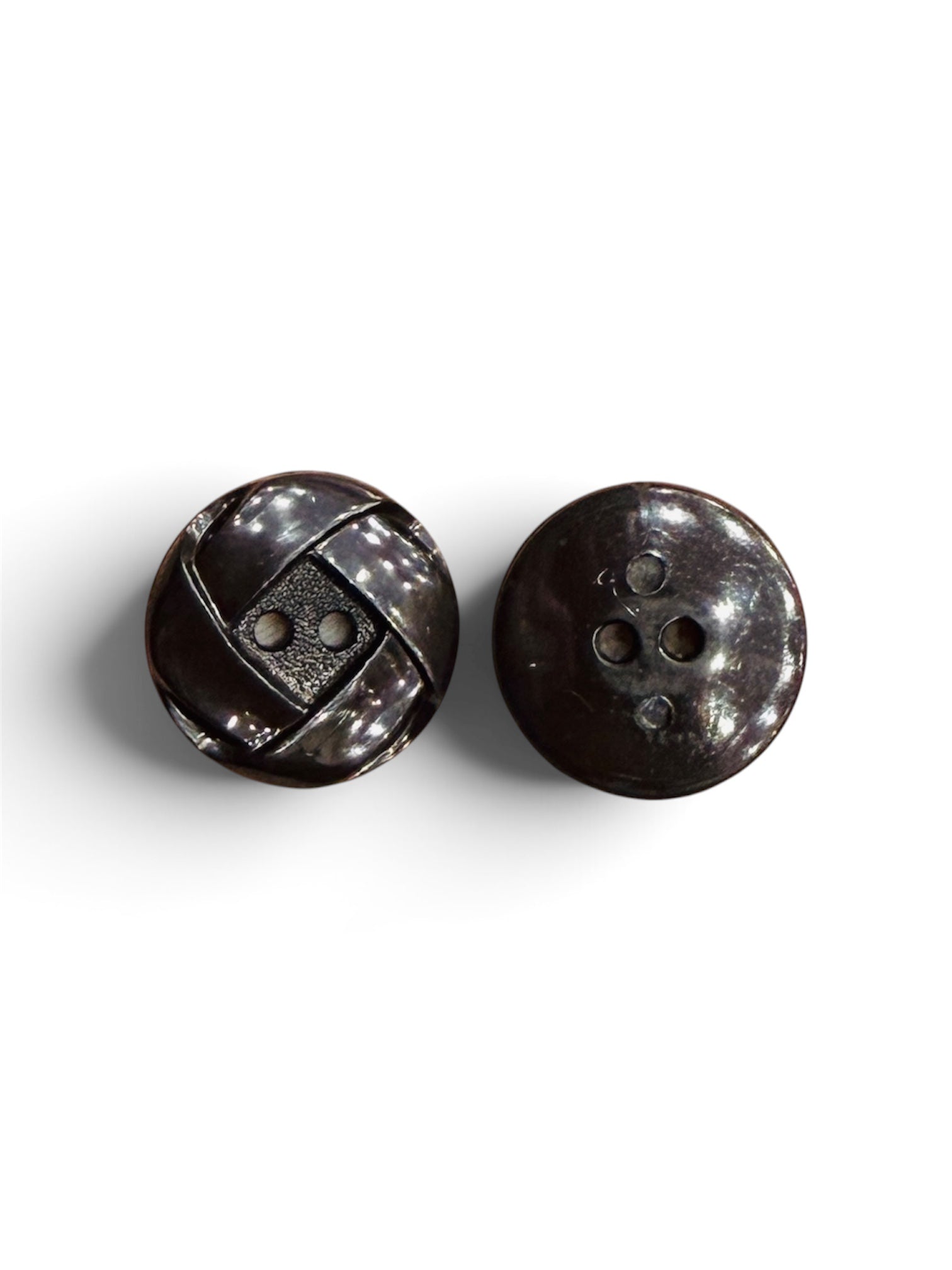 Two 20mm shiny black resin buttons with a 2-hole design and textured geometric pattern.