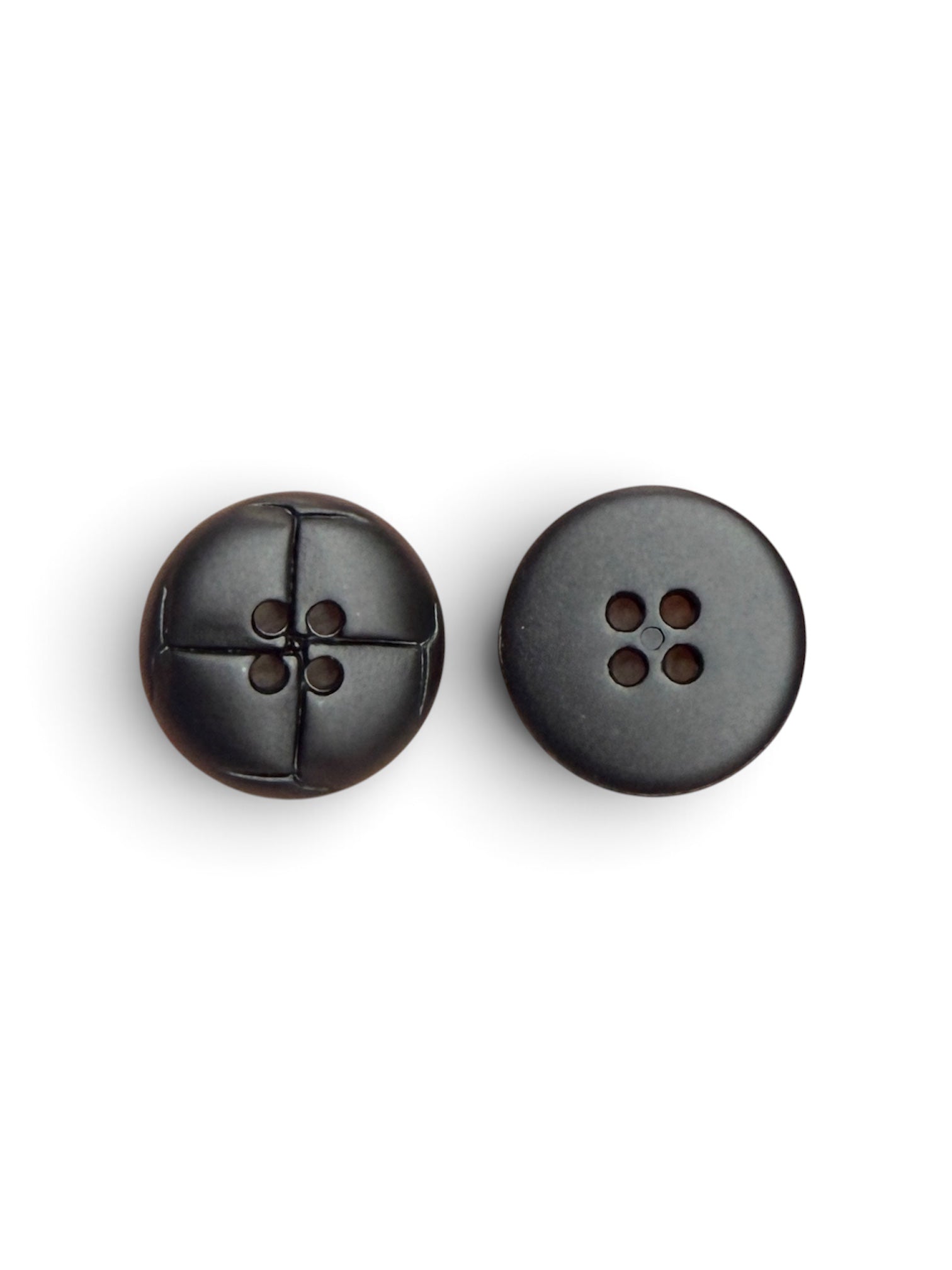 Two 20mm black matte resin 4-hole sewing buttons, one showing a cross-stitch detail.