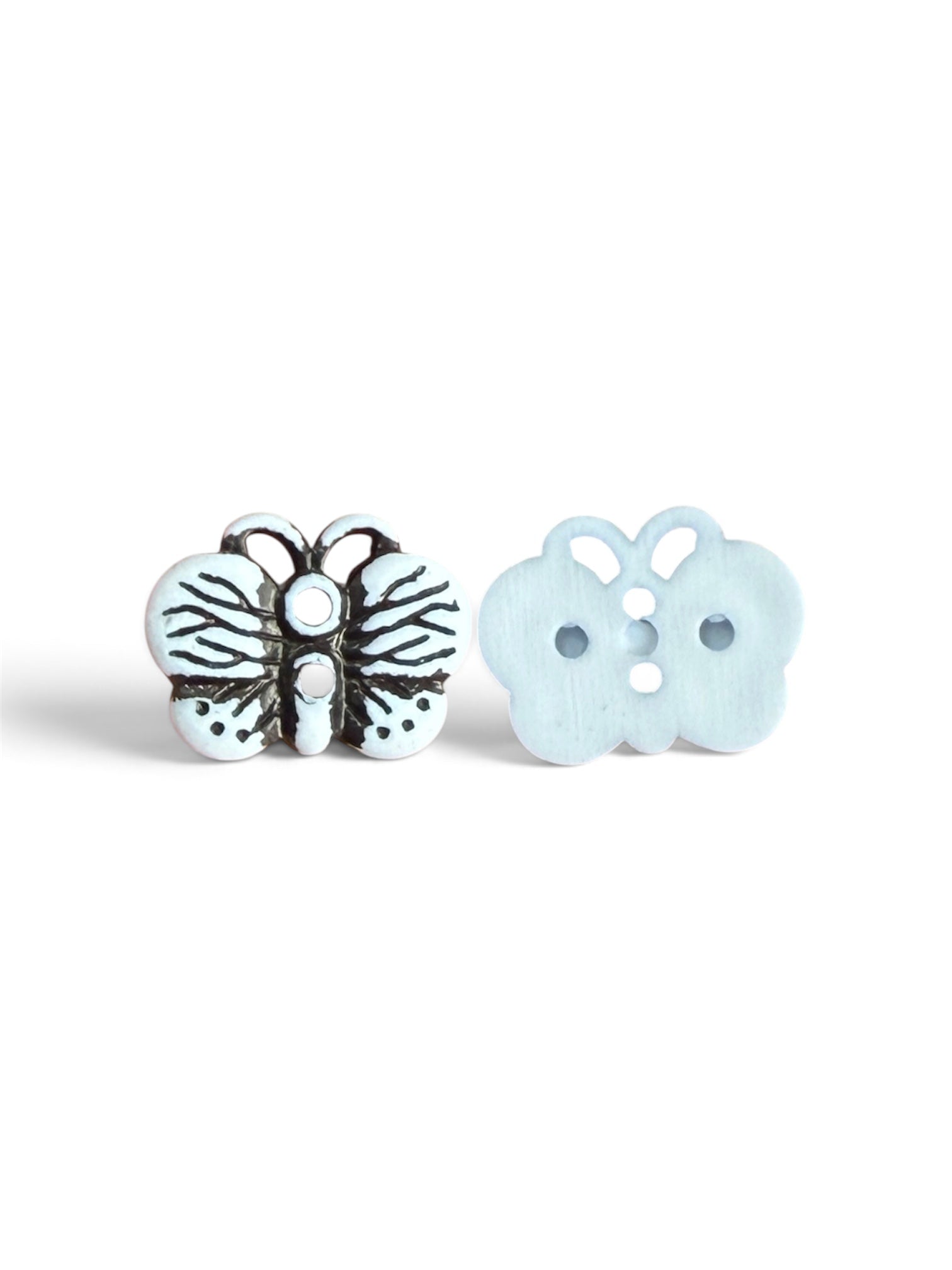 Two 17mm butterfly resin buttons in white, showing front with black details and back with 2 holes.