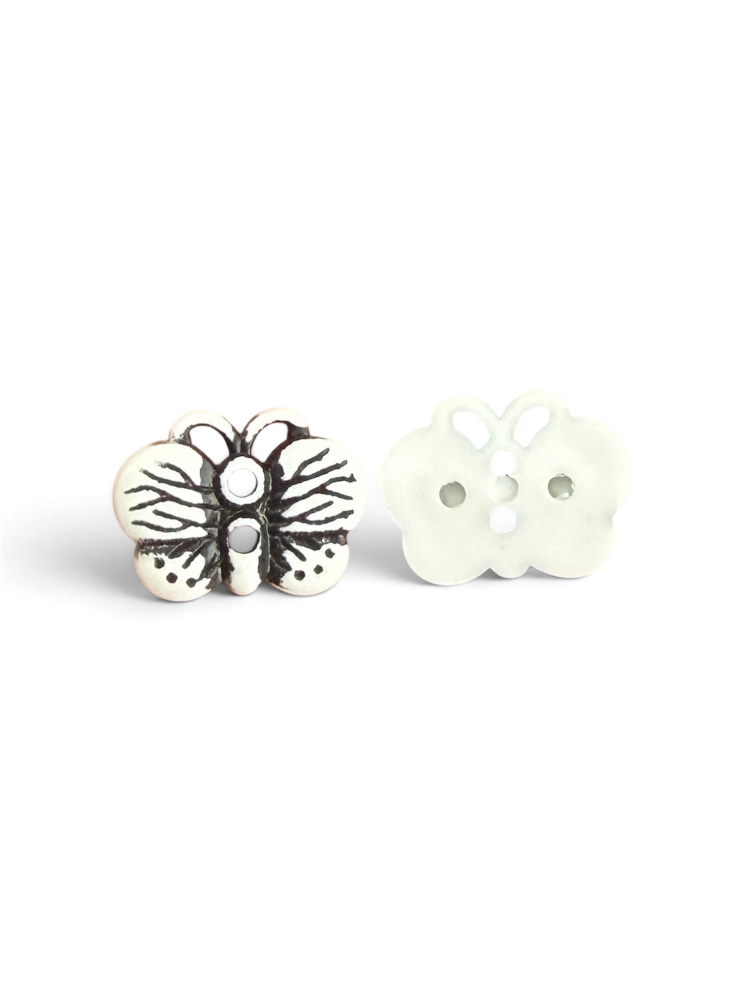 Front and back view of a white butterfly resin button with black wing details and two holes.
