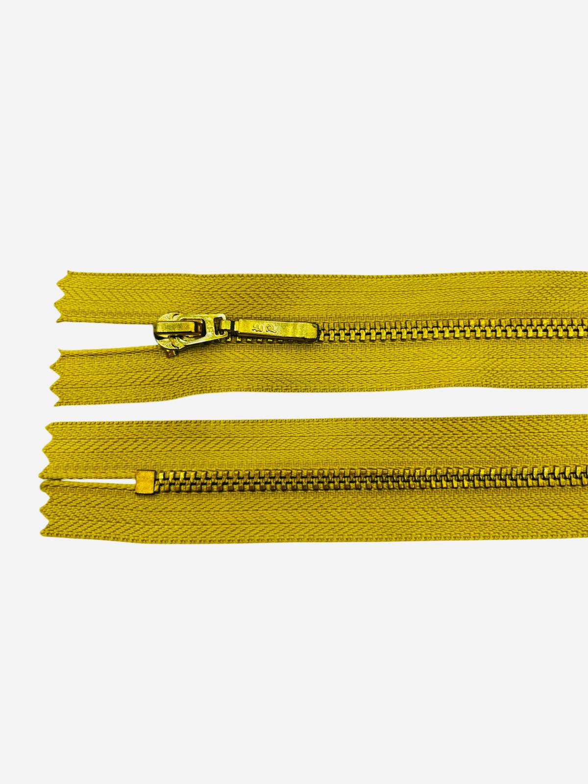 Two yellow zippers with gold metal teeth and sliders on a white background.
