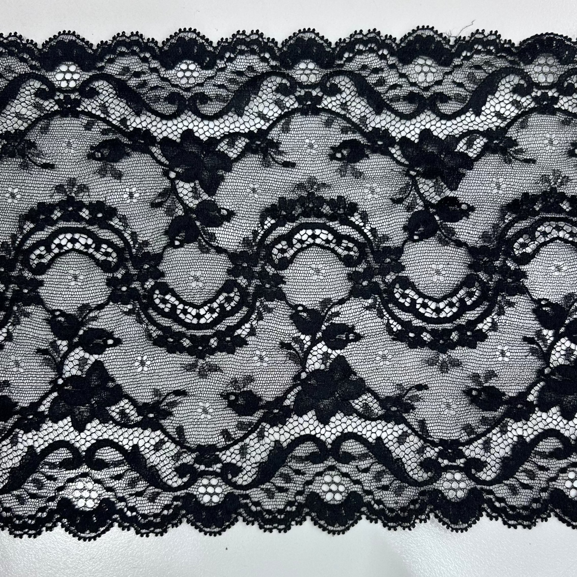 Black floral lace trim with a scalloped edge.