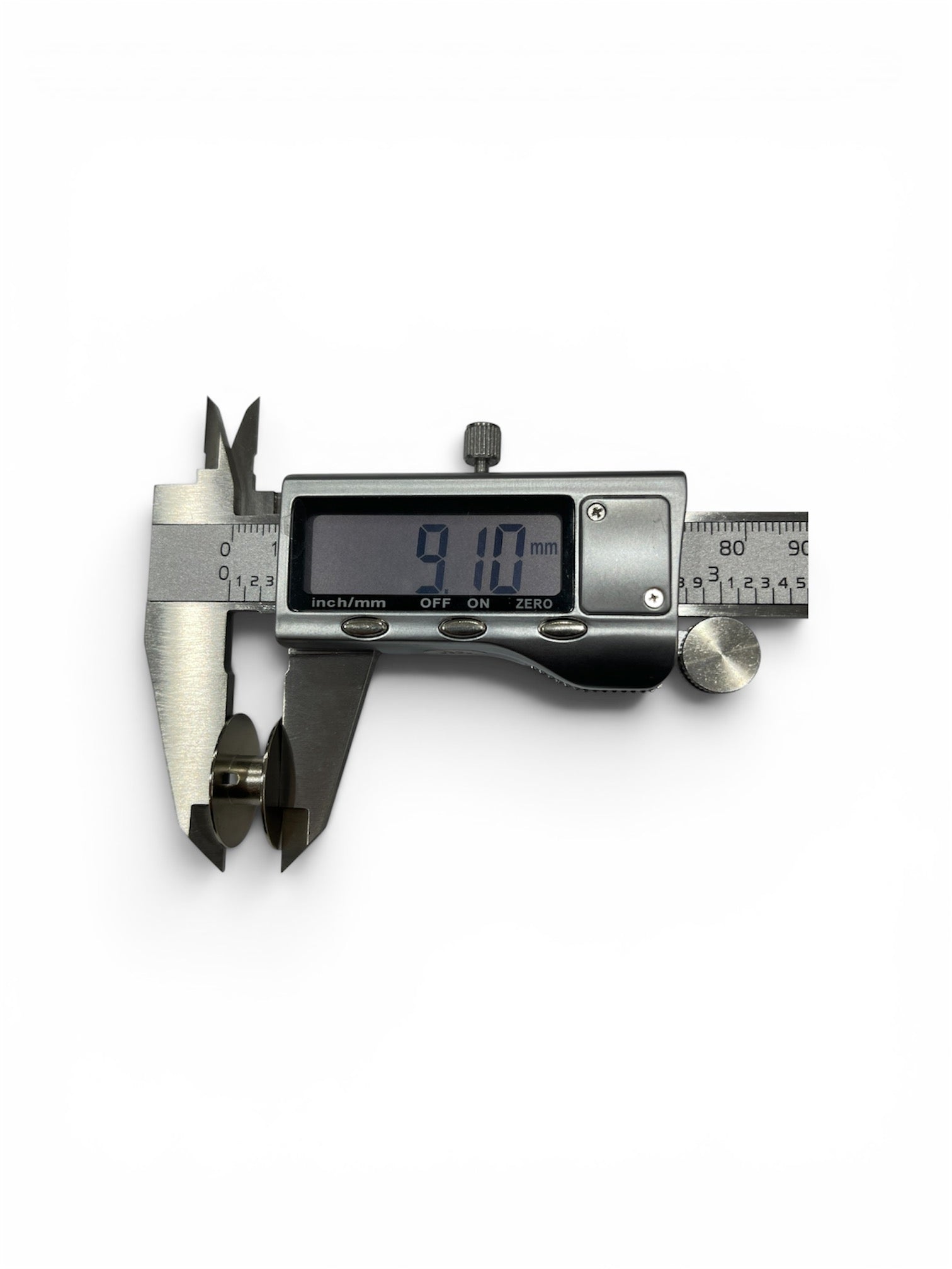 Janome Class 15 metal bobbin being measured with a digital caliper showing a 9.10 mm depth.