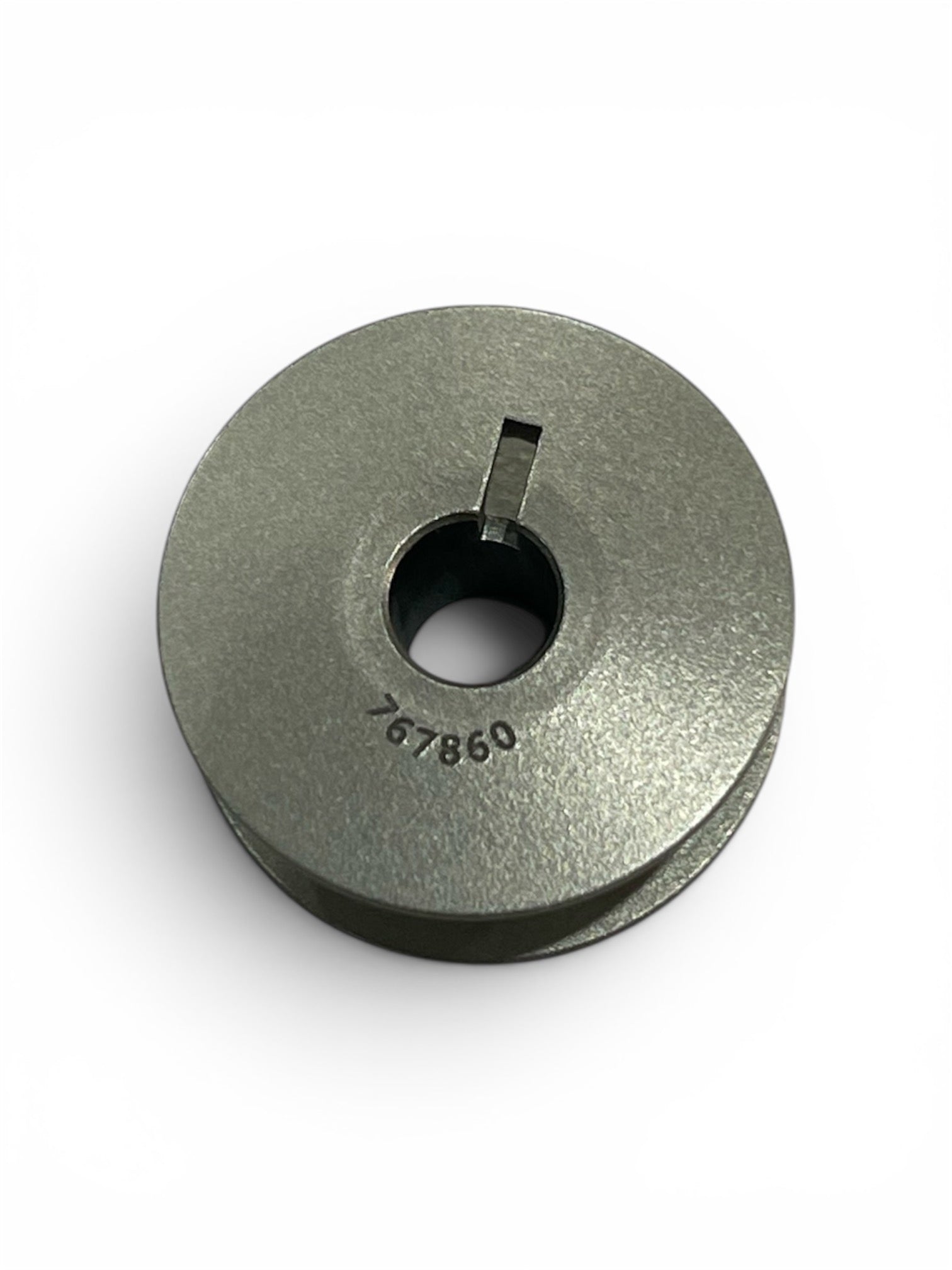 Genuine Janome HD9 V2 Jumbo Metal Bobbin with part number 767860 engraved on the surface.