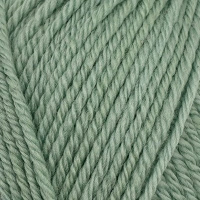 Close-up of Stylecraft Naturals Pure Wool DK yarn in a soft sage green color showing stitch texture.