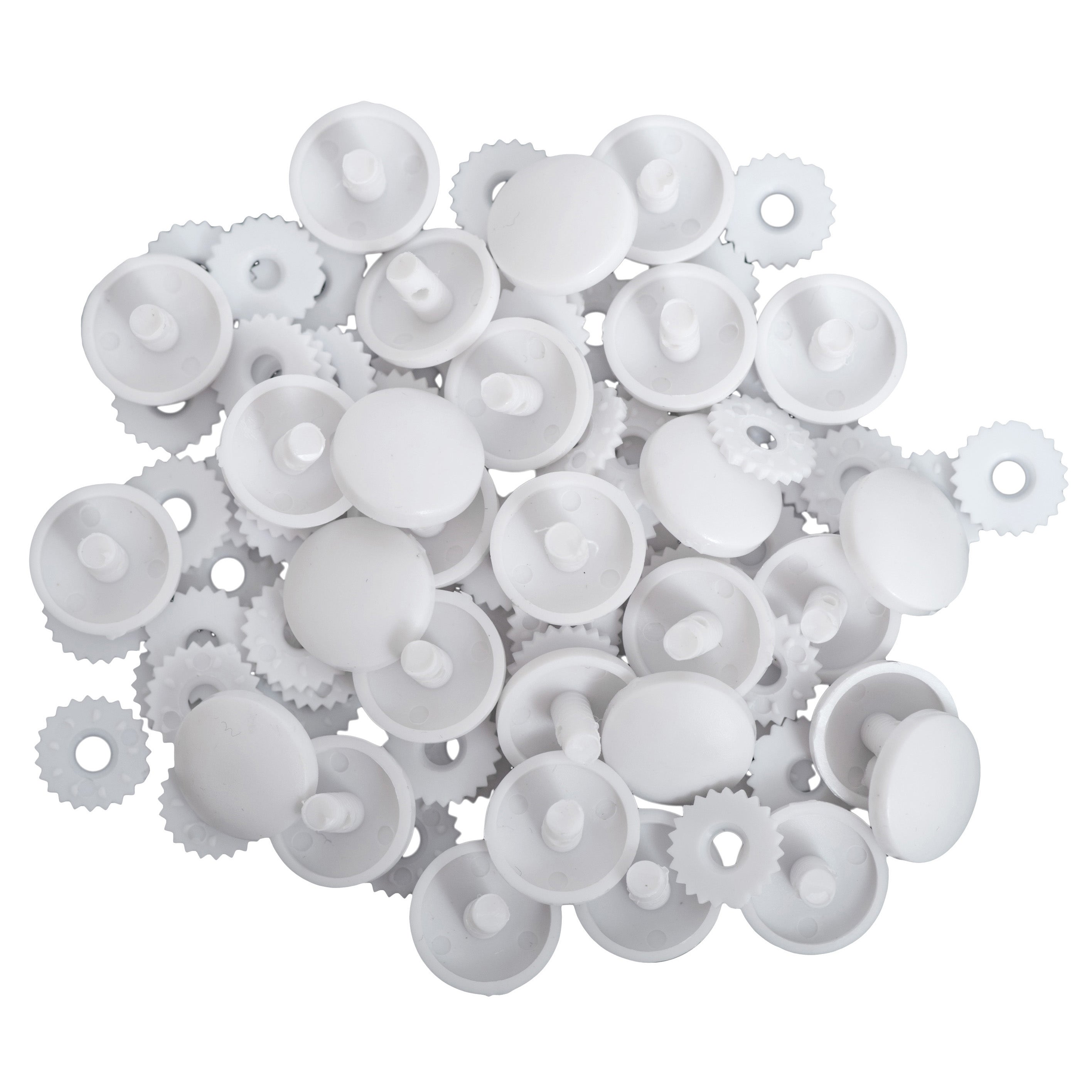 A pile of white nylon self-cover button components including snap-on back plates and front shells.