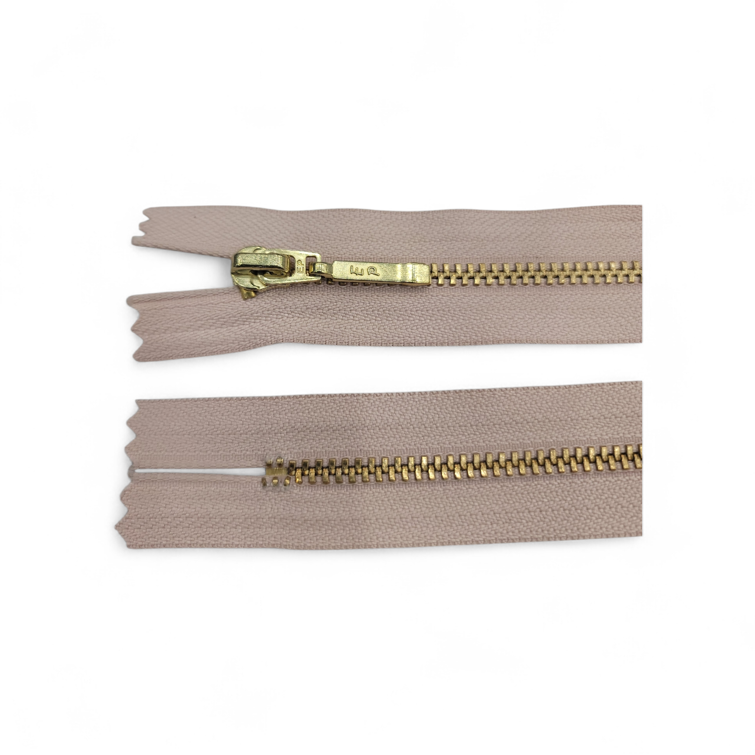 YKK size 3 closed end gold metal zip with beige tape.