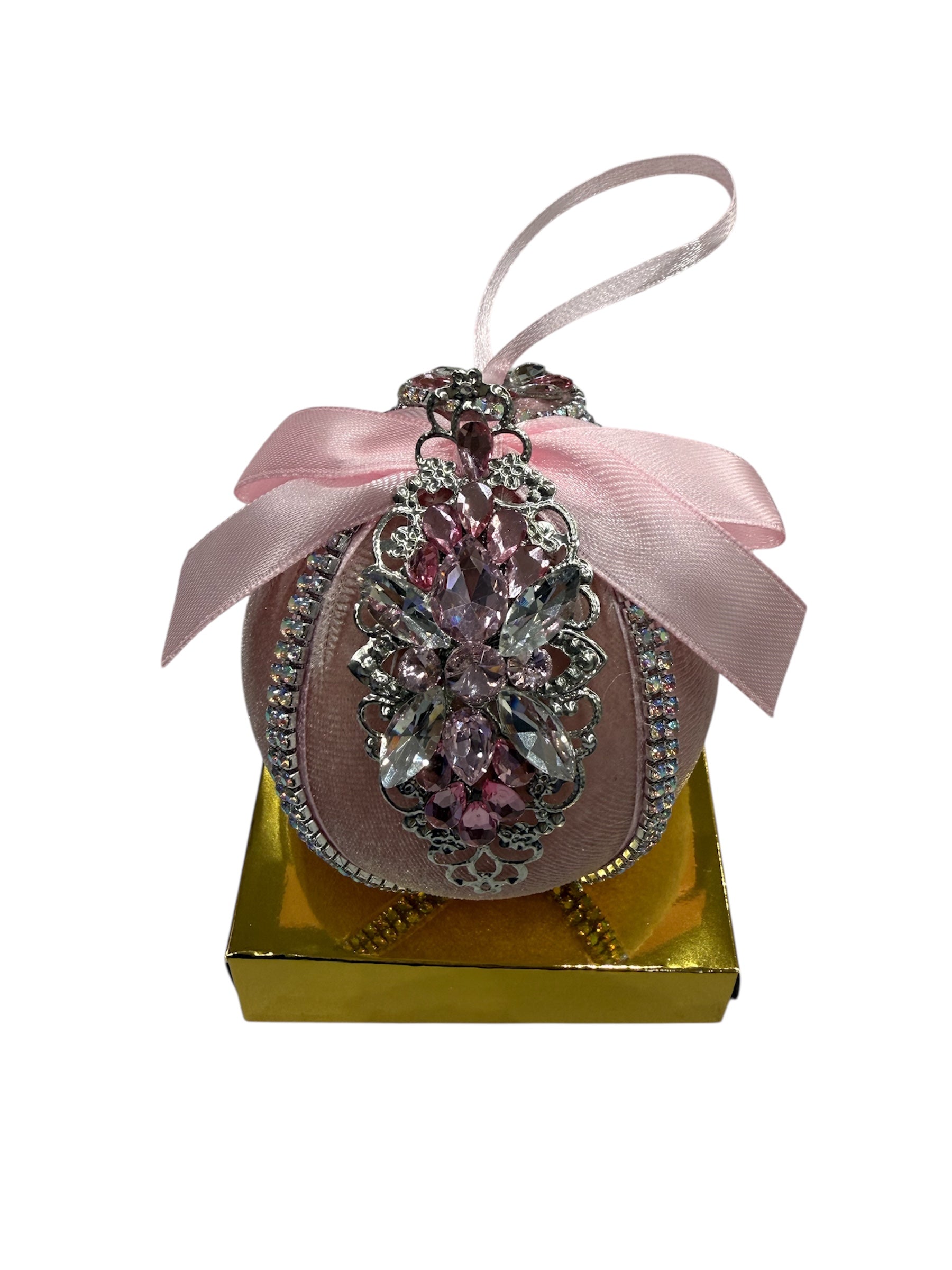 Round pink Christmas ornament with jewels and a pink ribbon.