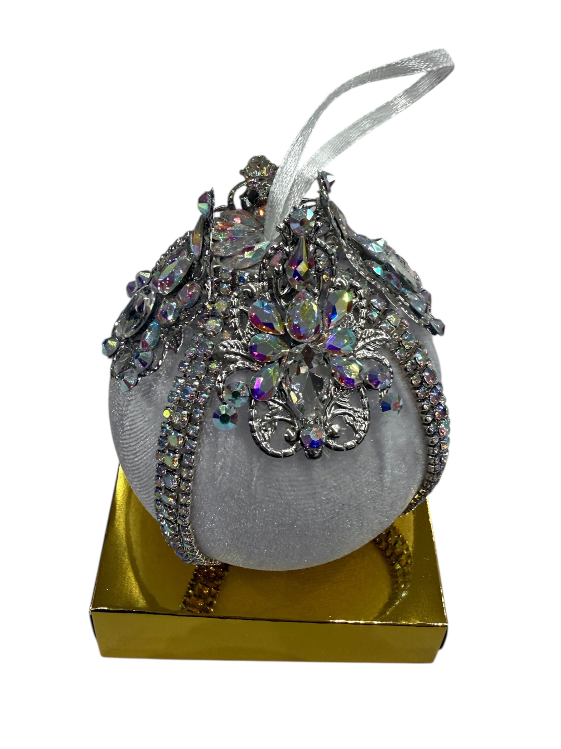 Round white Christmas ornament with silver and iridescent jewel embellishments.