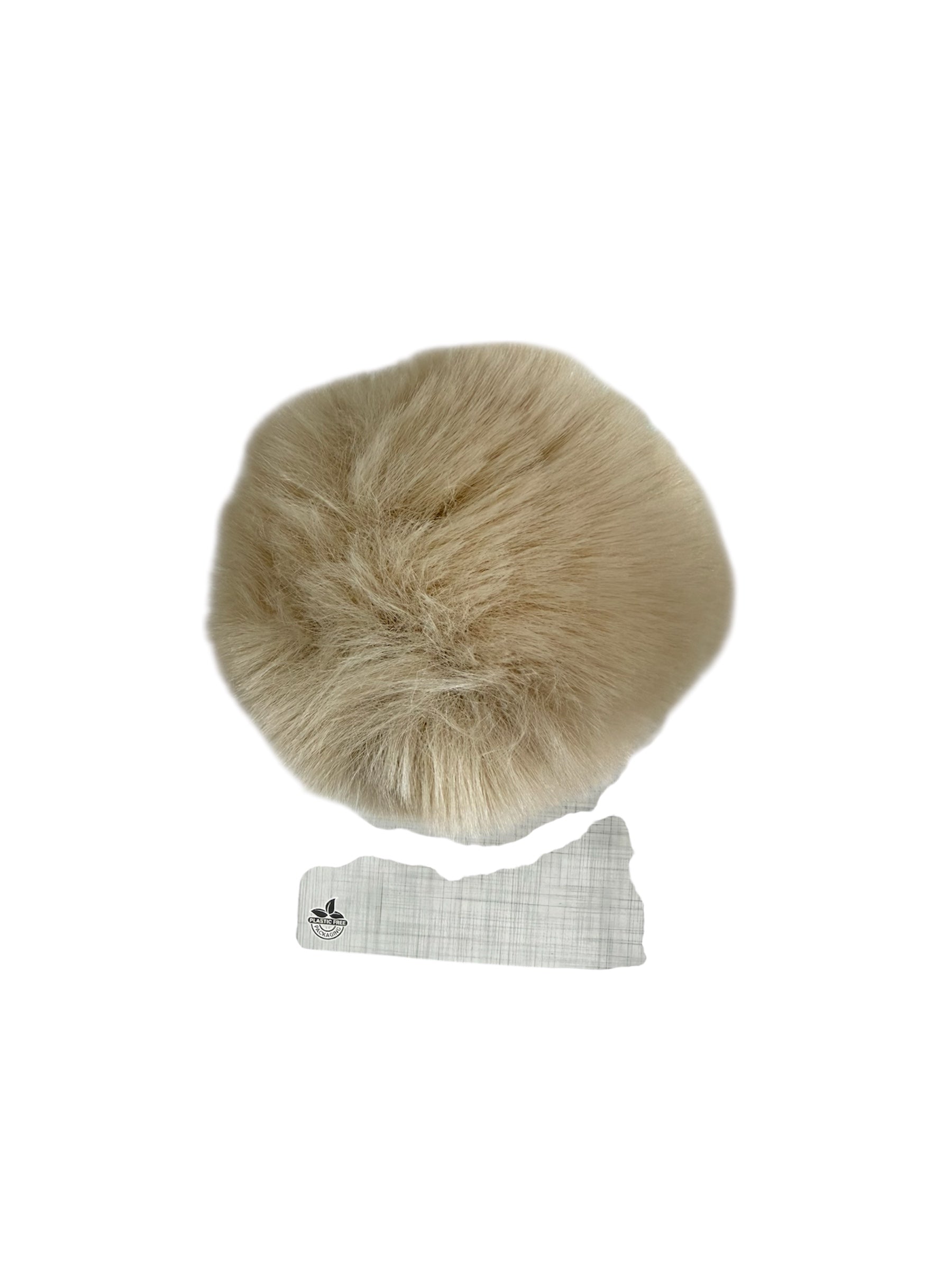 A beige faux fur pompom with a plastic-free packaging tag.