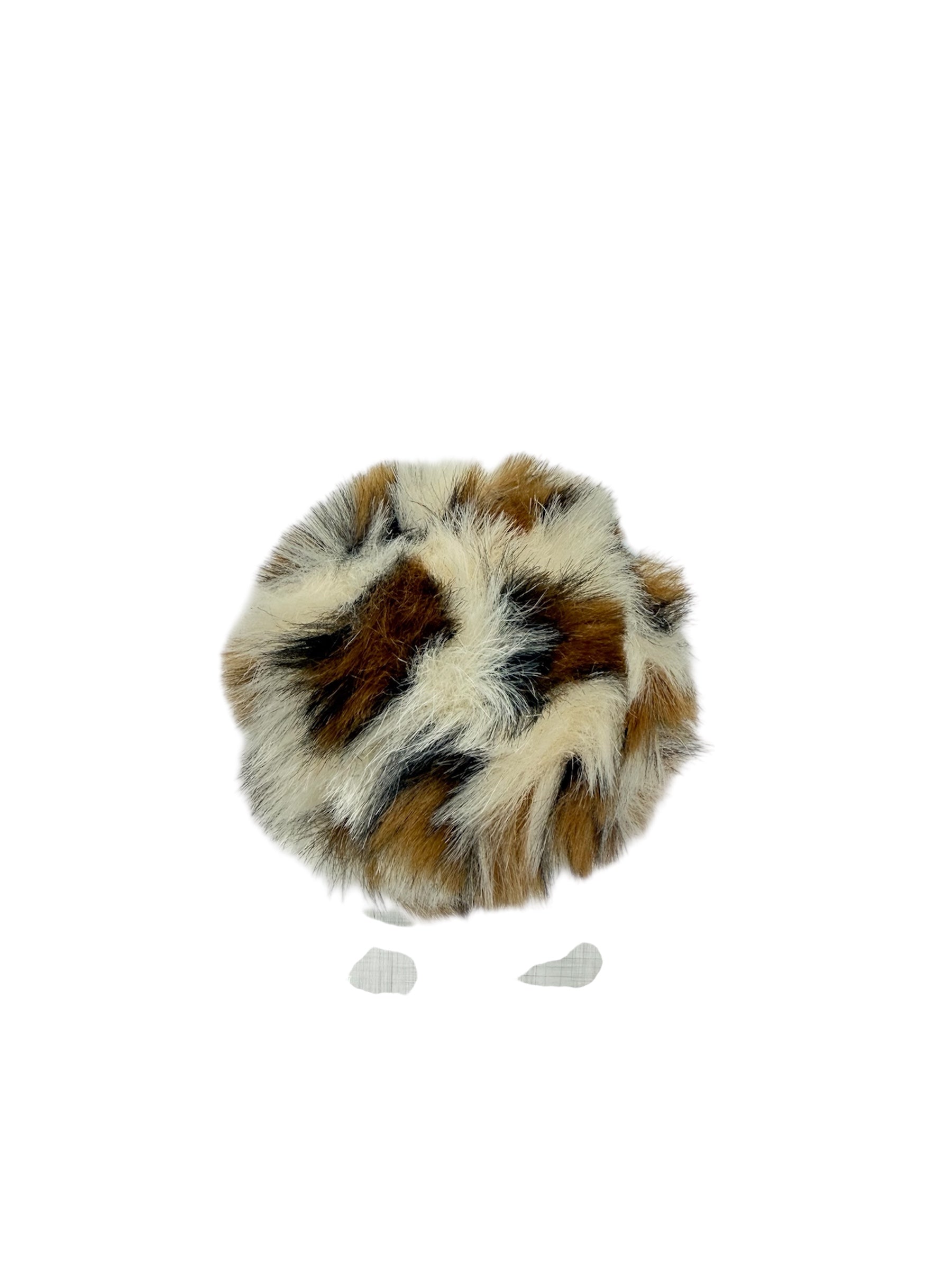 Trimits 11cm faux fur pompon in a brown, white, and black spotted pattern.