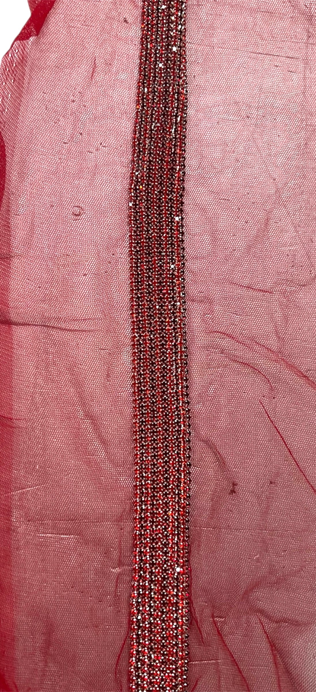 Red hand-beaded gem tape with a striped pattern.