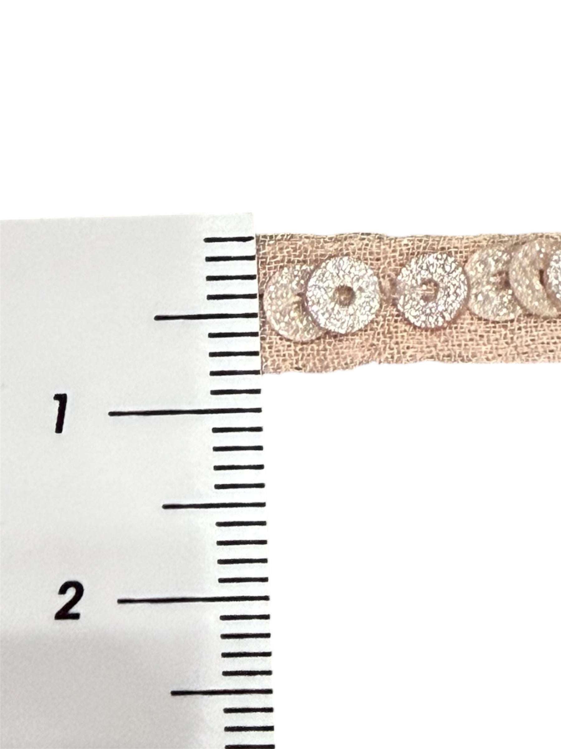Pink designer trim with metallic sequins on a woven strip.