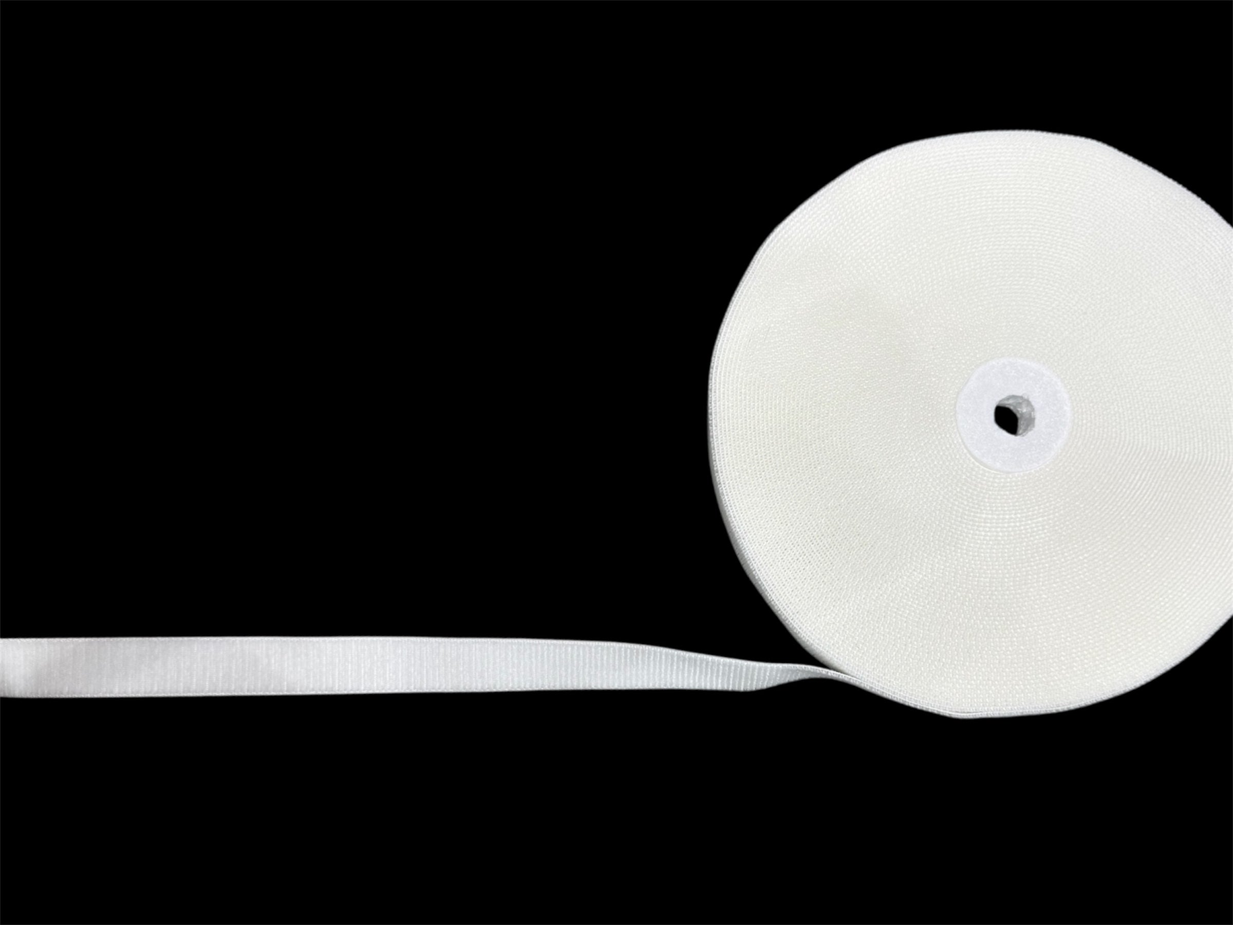 A roll of white Marushin soft hook and loop sticky tape shown against a black background.