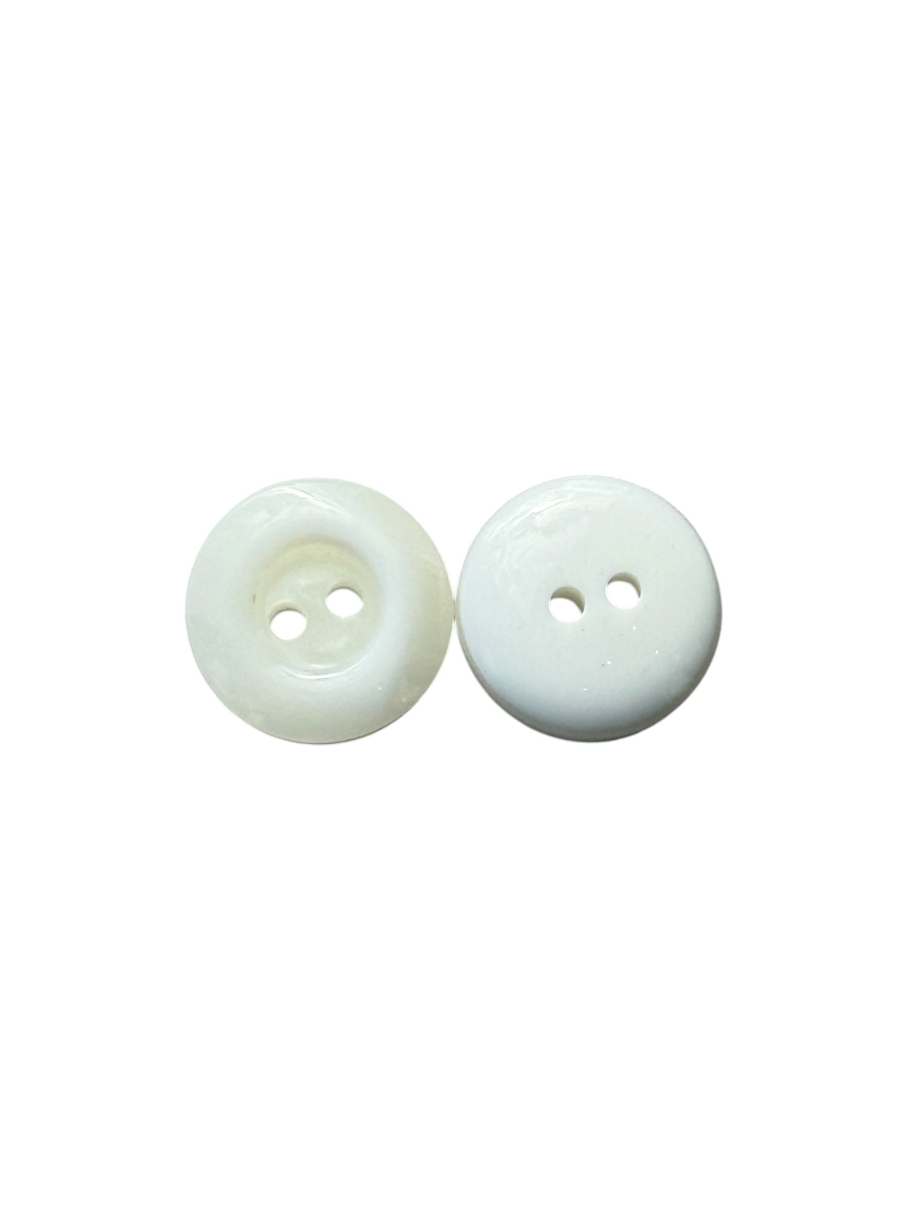 Two-hole plastic buttons showing a shiny ivory front and a solid white back.