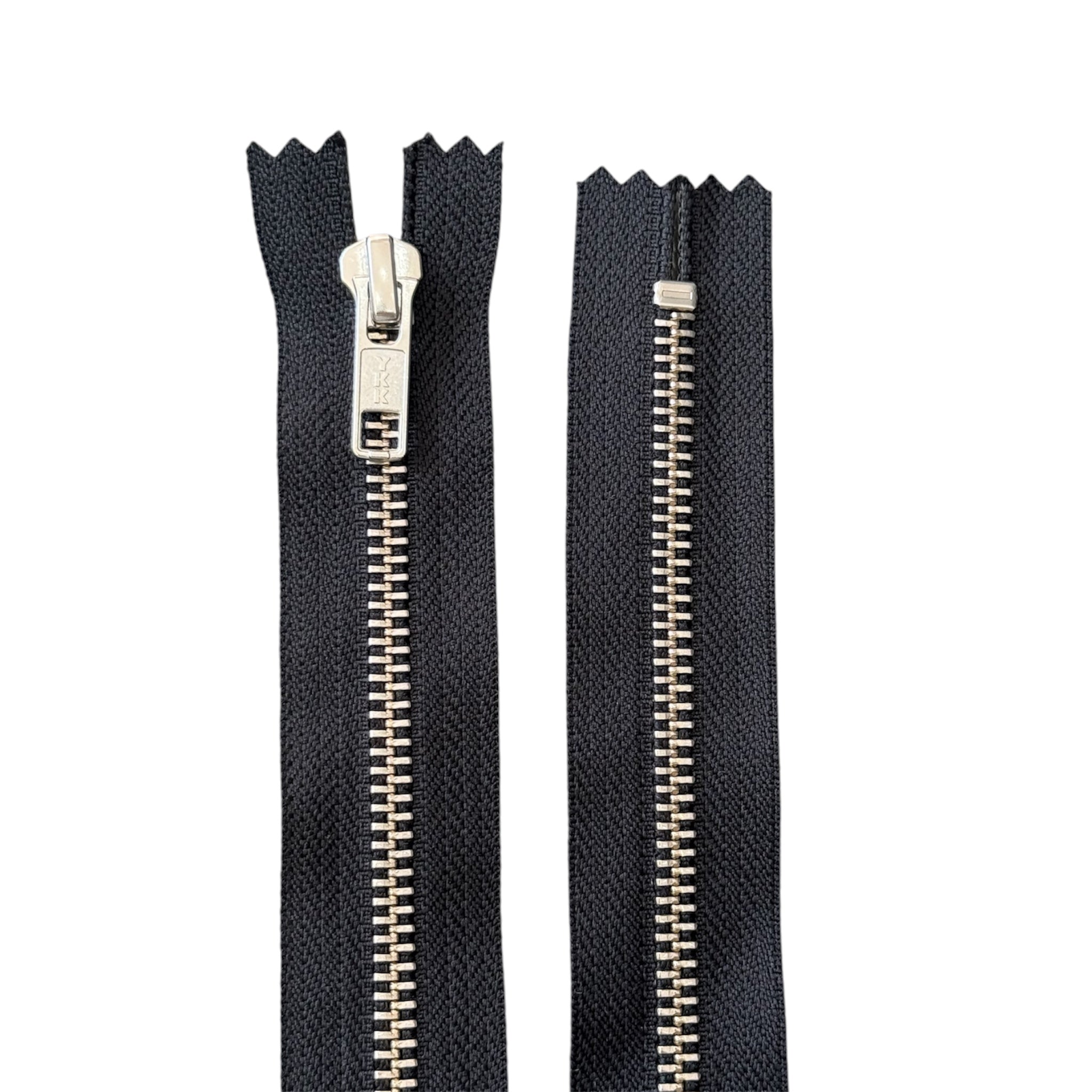 Two YKK black closed-end zippers with silver metal teeth and sliders on a white background.