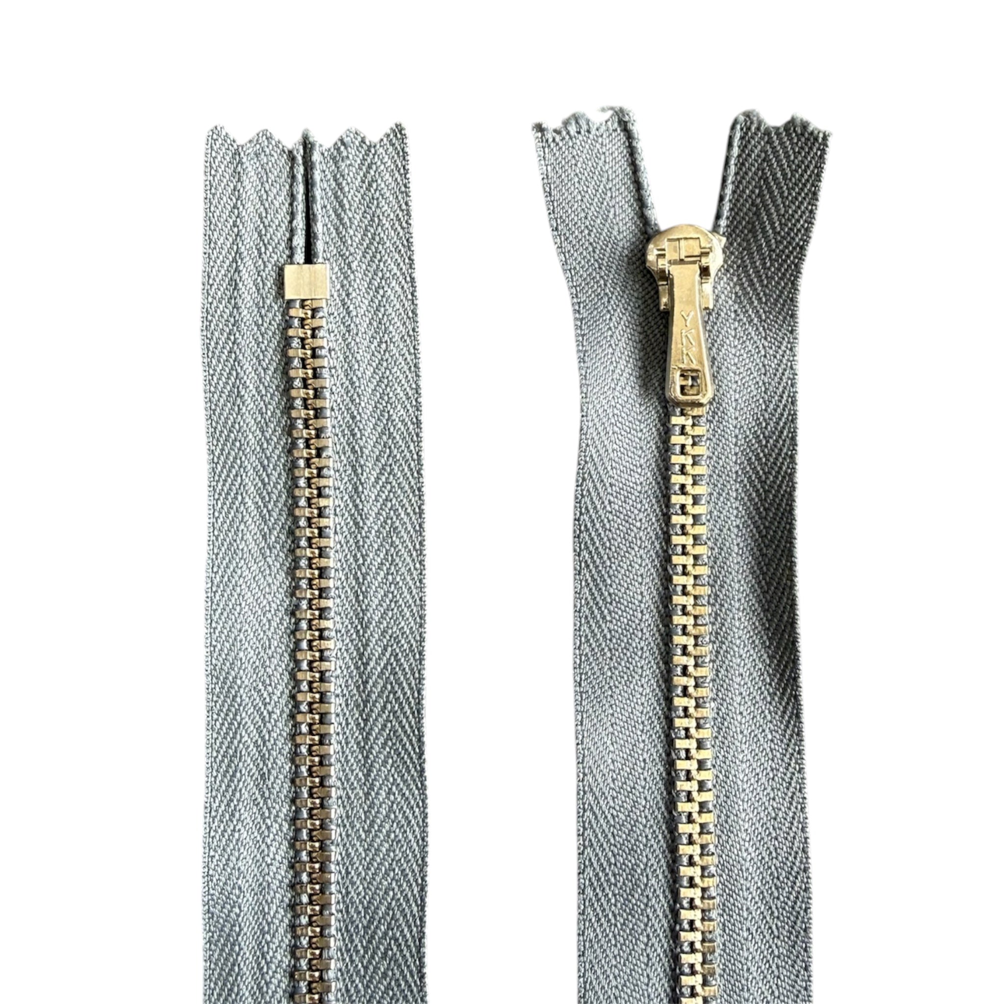 YKK 23cm closed end metal zipper with silver teeth and grey tape, front and back views.