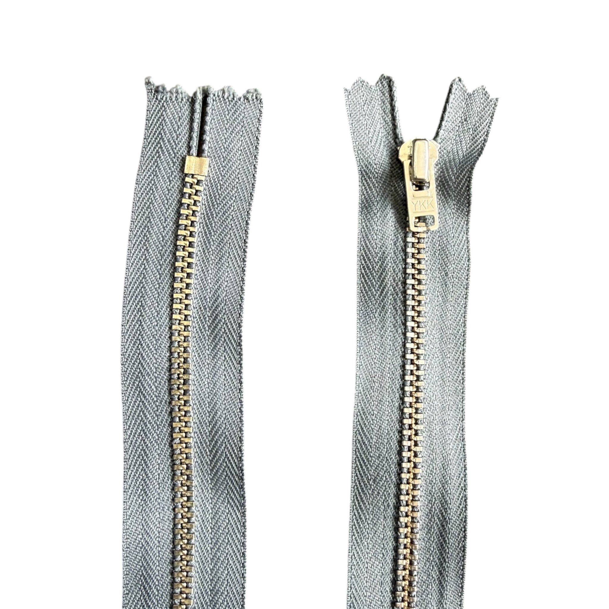 YKK 18cm grey closed-ended zipper with silver metal teeth and pull tab.
