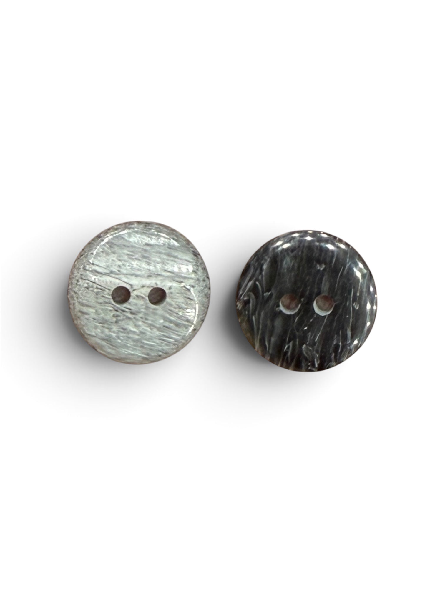 Two 15mm round 2-hole sewing buttons in light and dark grey marbled patterns.