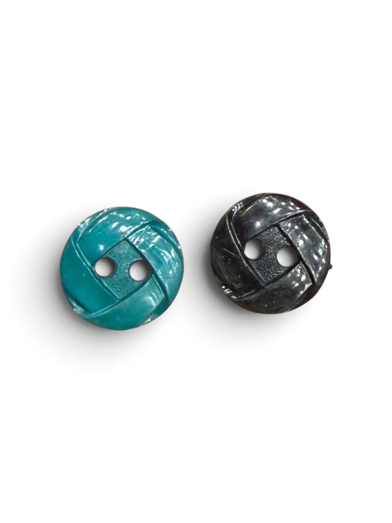 Two 14mm circular resin sewing buttons in teal green and black with a textured 2-hole design.