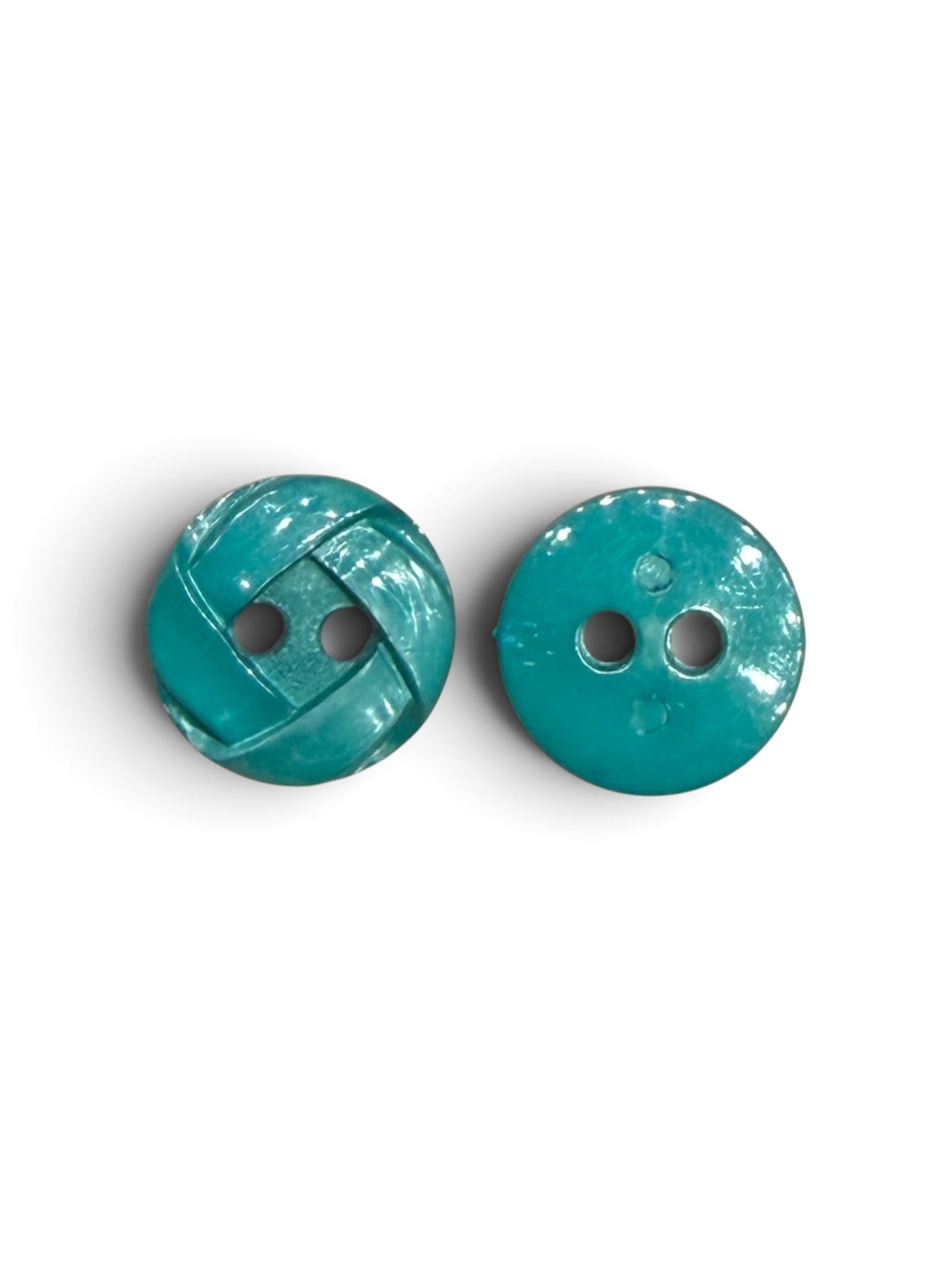 Two 14mm teal green resin 2-hole circular sewing buttons, one with a textured woven pattern.