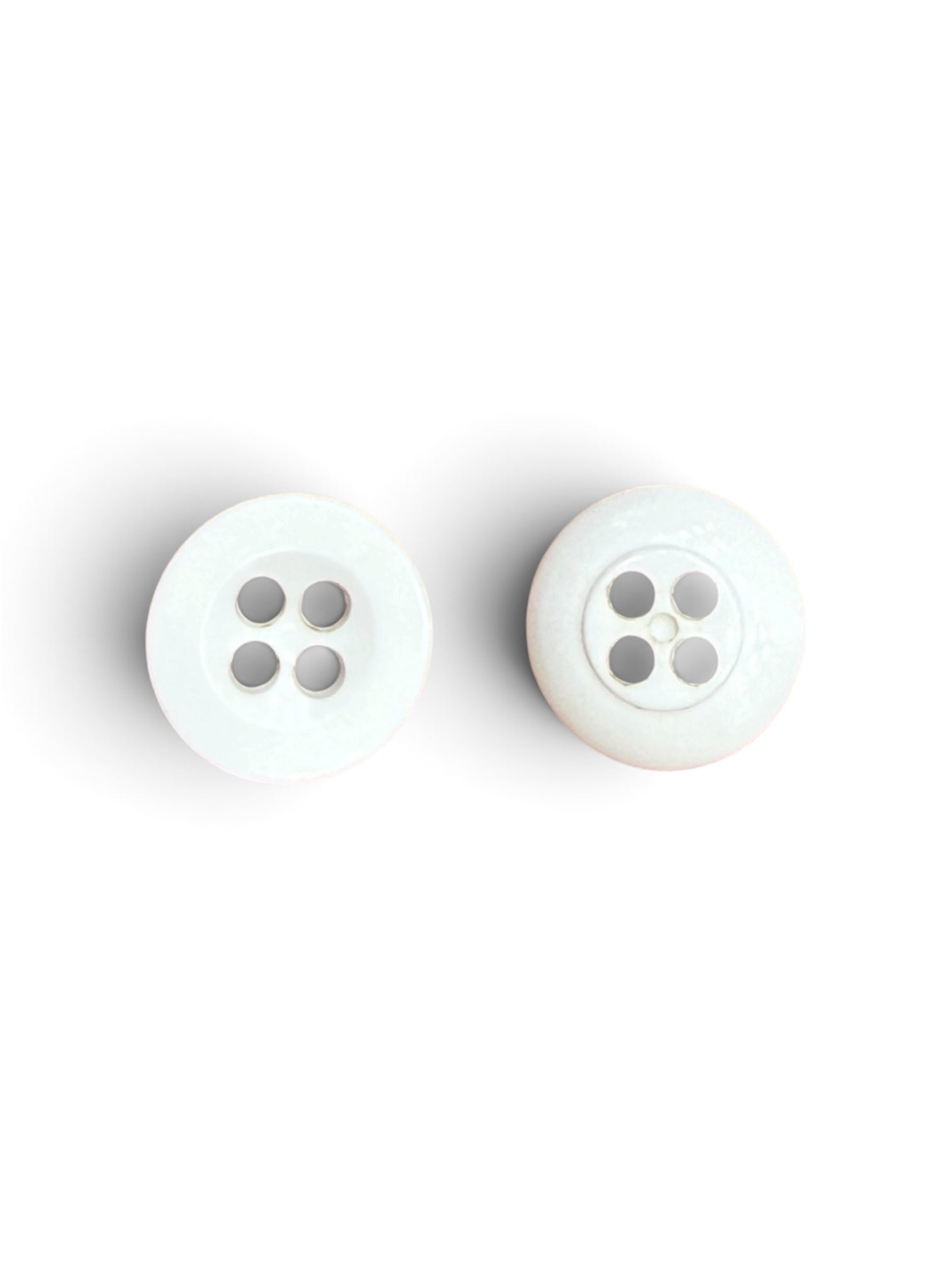 Two white resin buttons with four holes each.