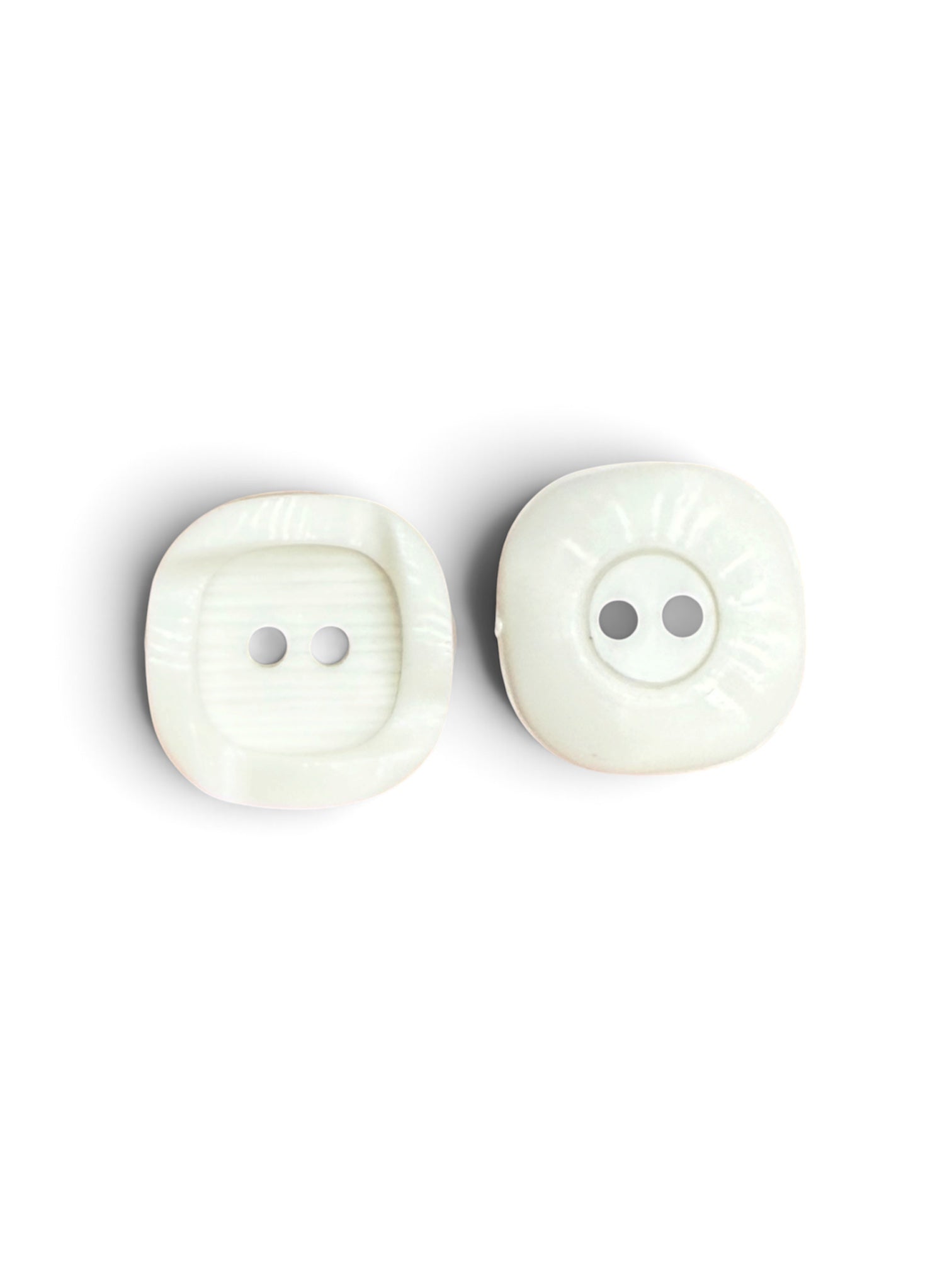 Two white textured resin sewing buttons with two holes each.