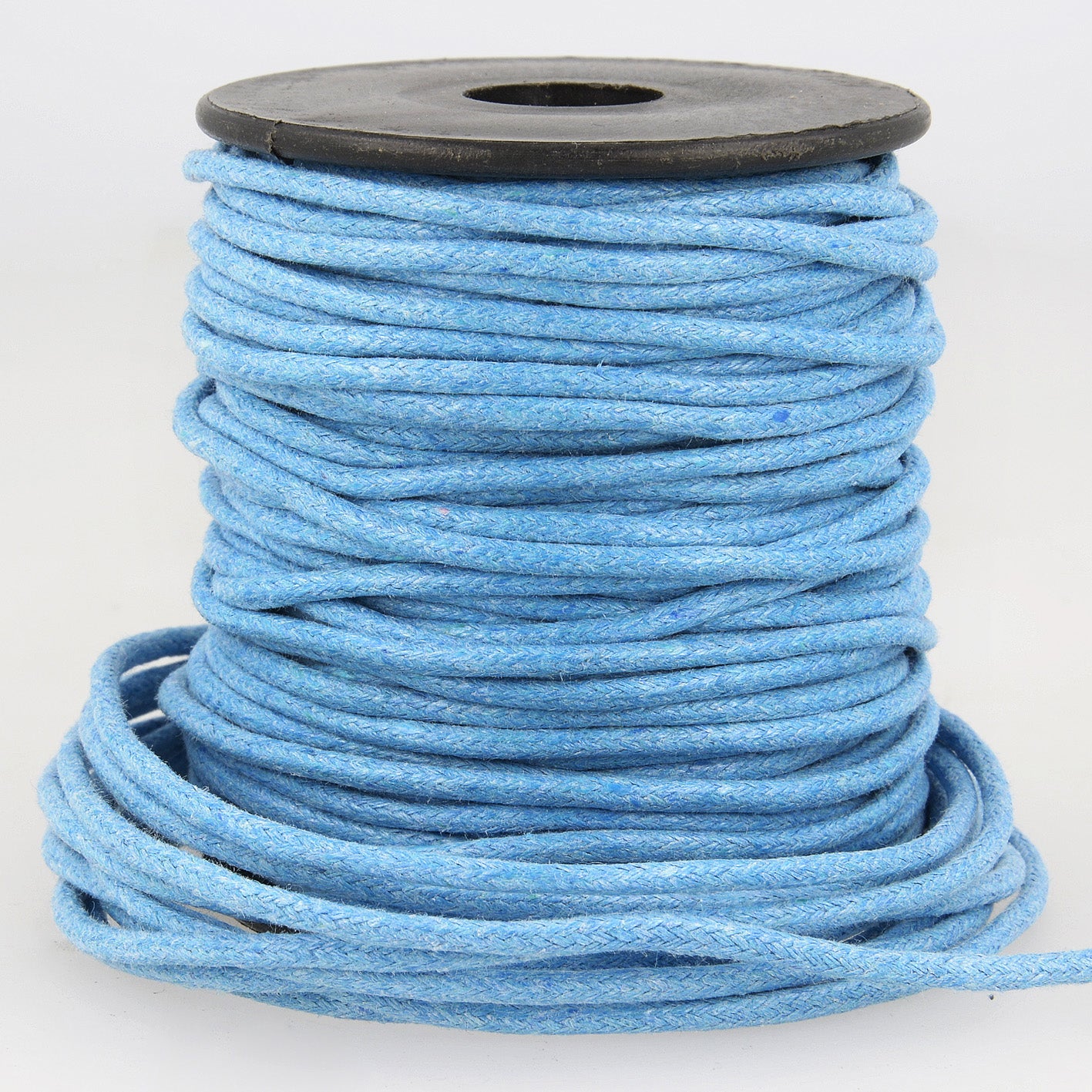 A spool of 2mm light blue faux leather cord with a textured, braided finish.