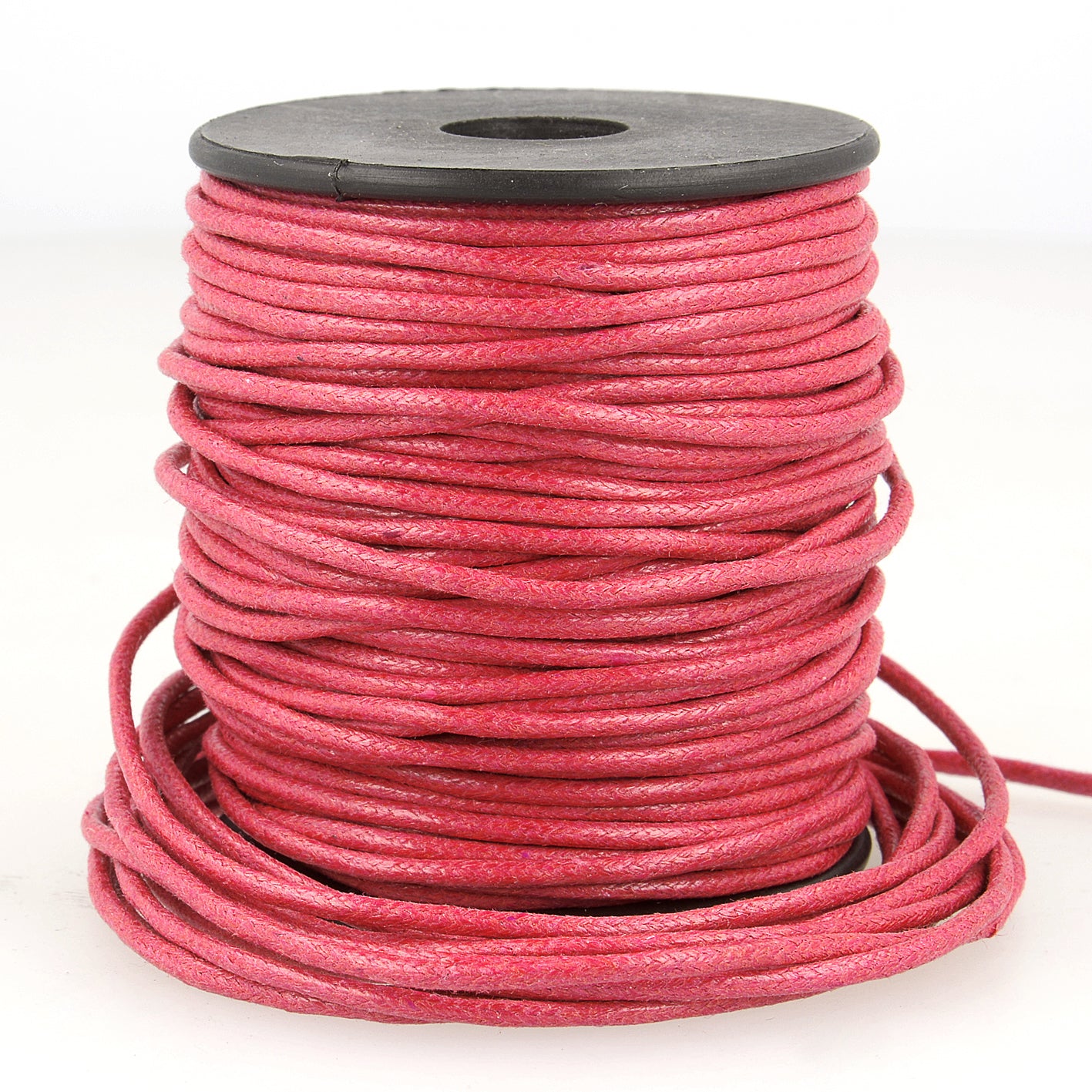 A spool of 2mm pink faux leather cord with a textured finish for jewelry and garment projects.