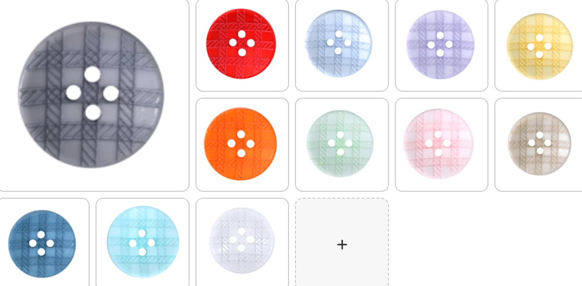 A collection of round, recycled 4-hole buttons in various plaid colors.