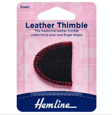 Small black leather thimble with red stitching on a pink Hemline brand retail card.