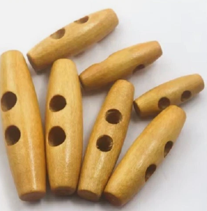 A collection of 40mm light-colored wooden toggle buttons with two holes for sewing.
