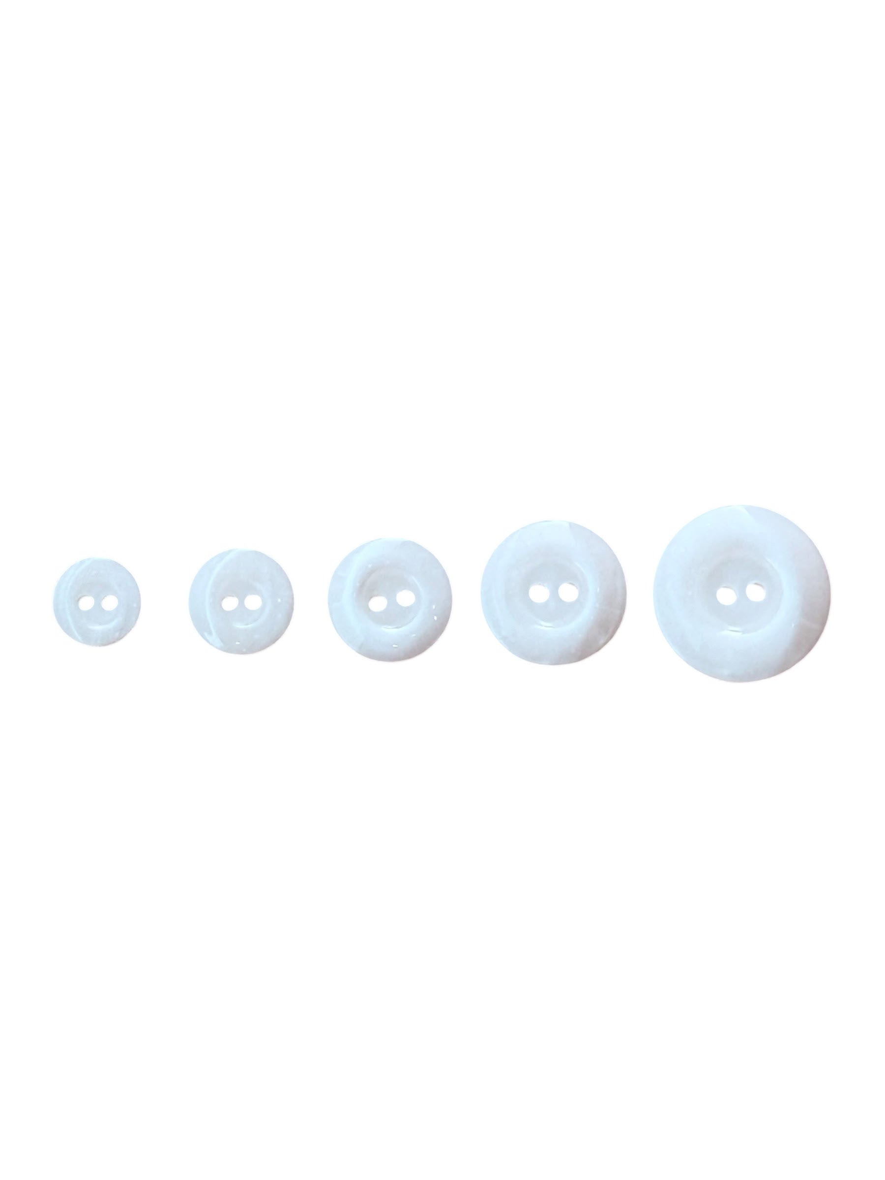 Five round, two-hole plastic buttons in ivory are shown in a row from smallest to largest.