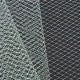 A close-up of a grey, diamond-patterned birdcage veil netting.