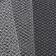 A close-up of two textures of grey polyamide netting, one lighter and one darker.