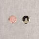 Two 21mm round buttons, one pink and one silver, on a grey background.